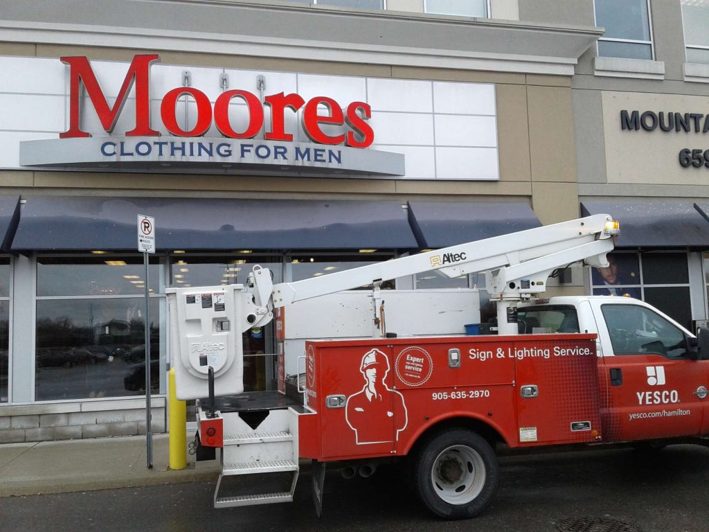 Moores clothing for men sign with red letters