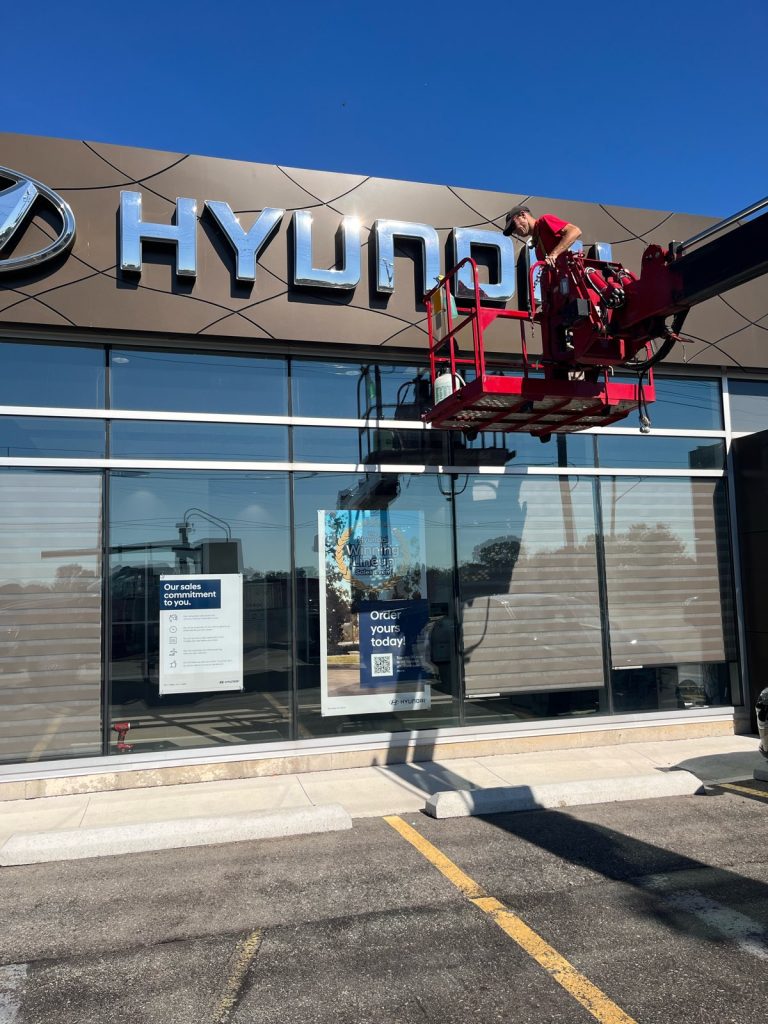 Hyundai Dealership sign being service by YESCO with bucket ladder