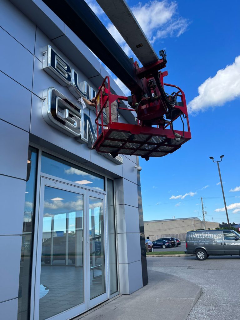 YESCO bucket ladder servicing the building sign at Buick GMC in Sarnia
