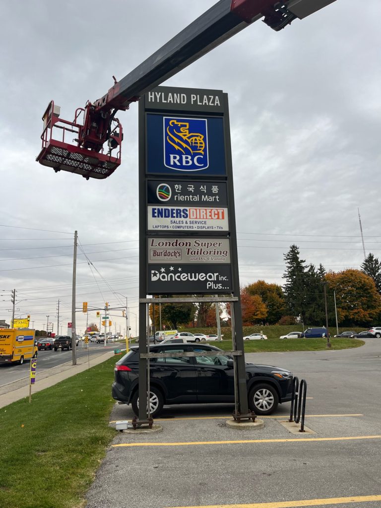 YESCO servicing Hyland Plaza sign with bucket ladder