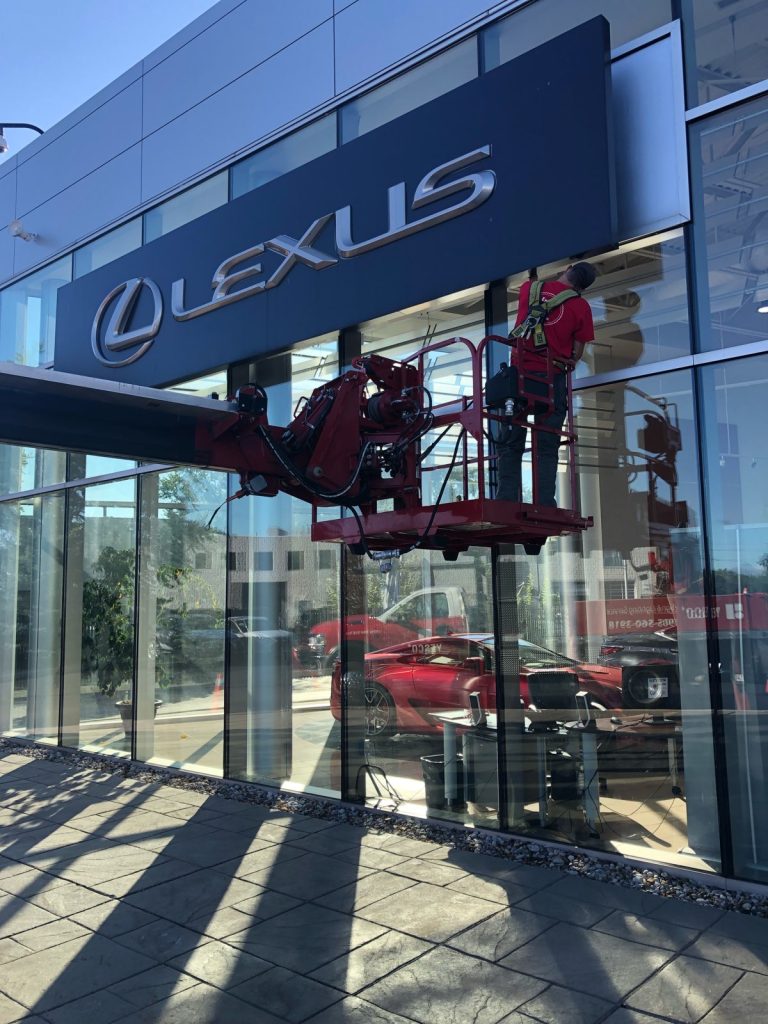 Yesco bucket ladder servicing the Lexus dealership sign outside