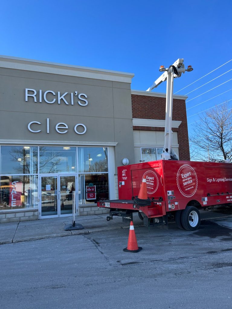 red YESCO truck servicing the Rick's sign