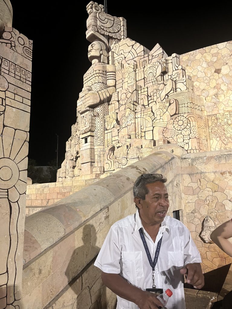 night shot in Mexico of a tour guide at a stone structure