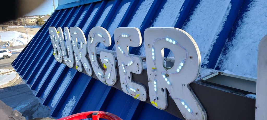 Burger King sign with lights on a blue roof