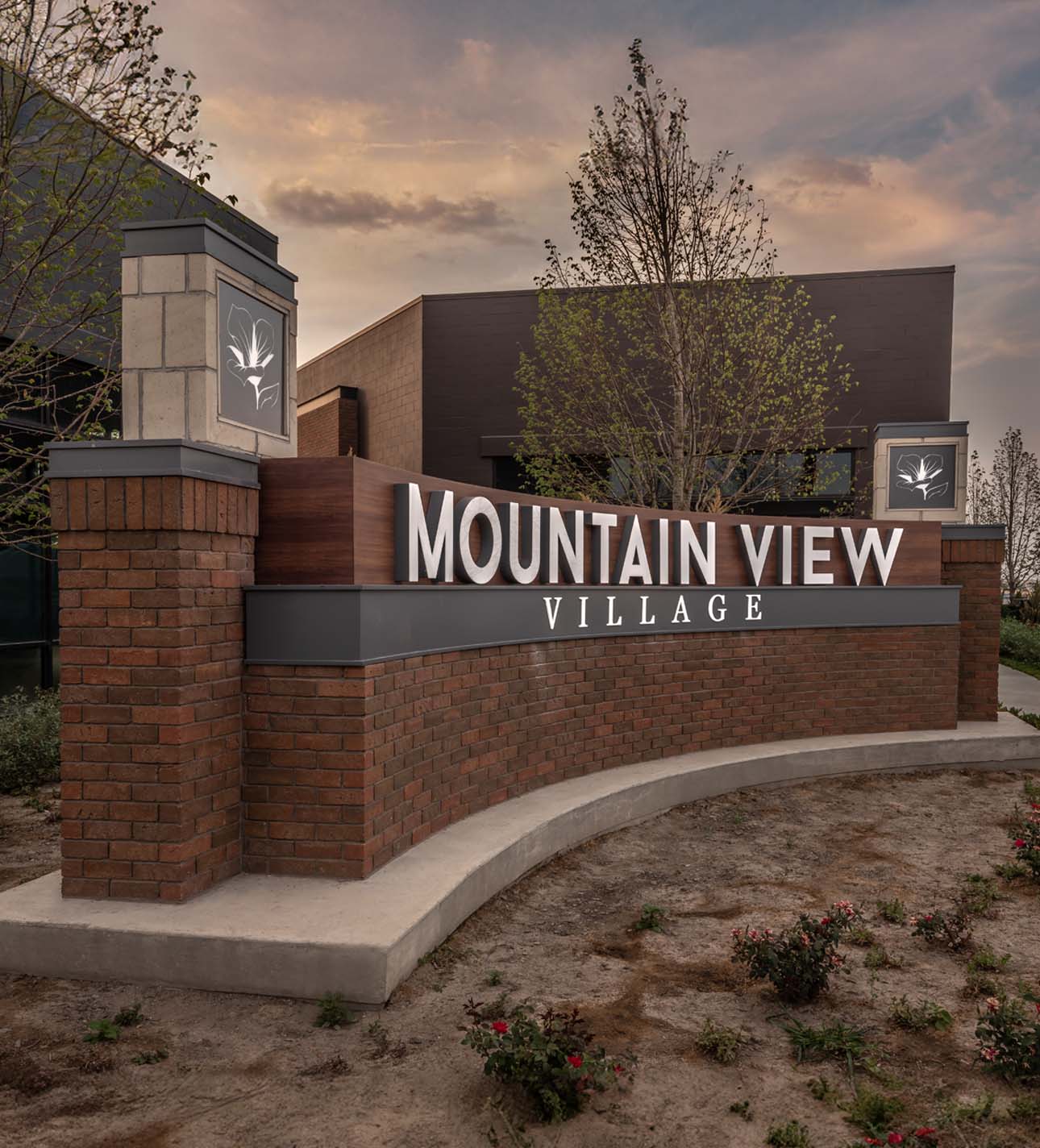 A brick and stone sign for Mountain View Village stands