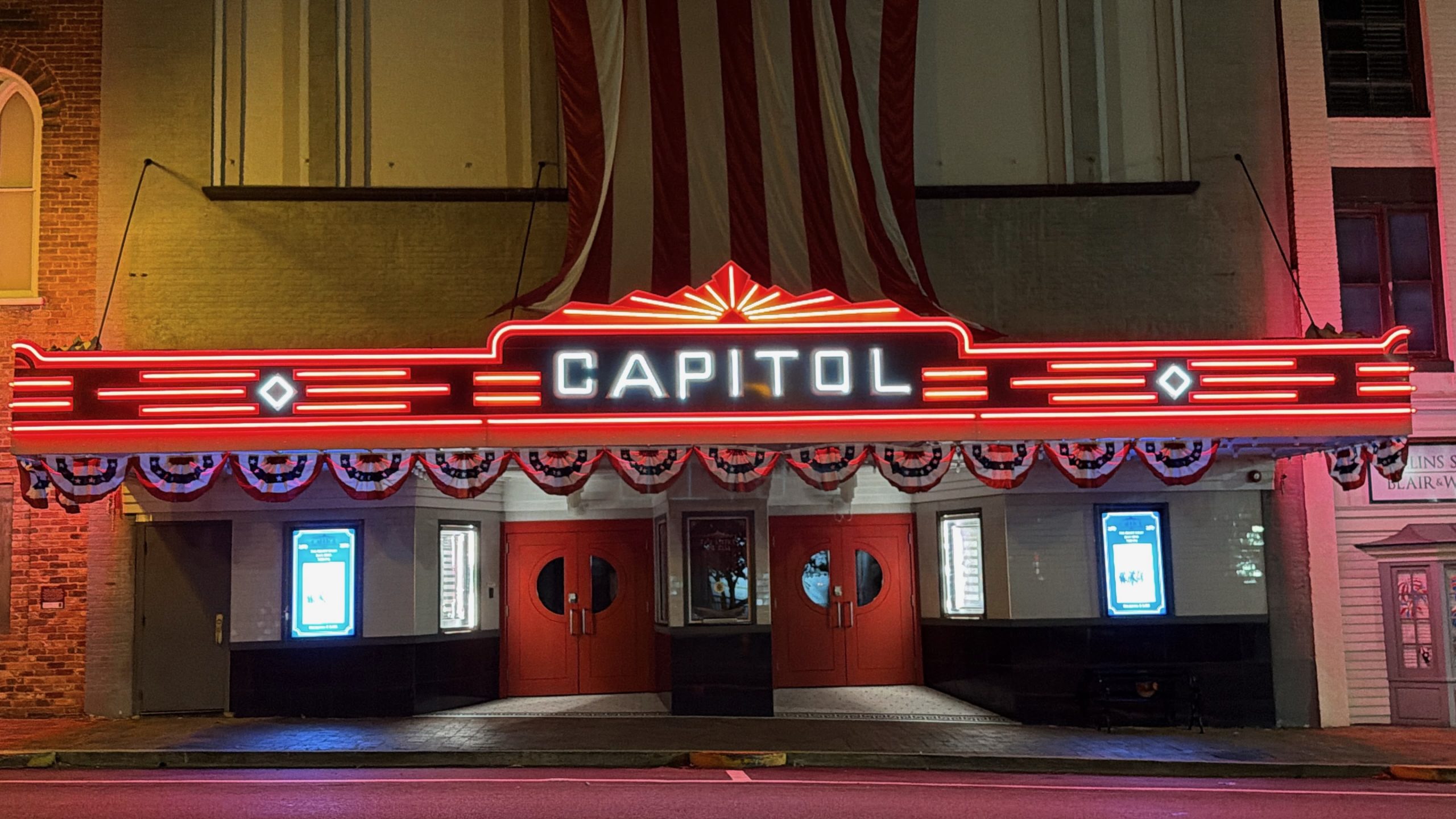 The restored Capitol Theatre marquee in Greeneville, Tennessee glowing at night with new RGB LED lighting installed by YESCO.
