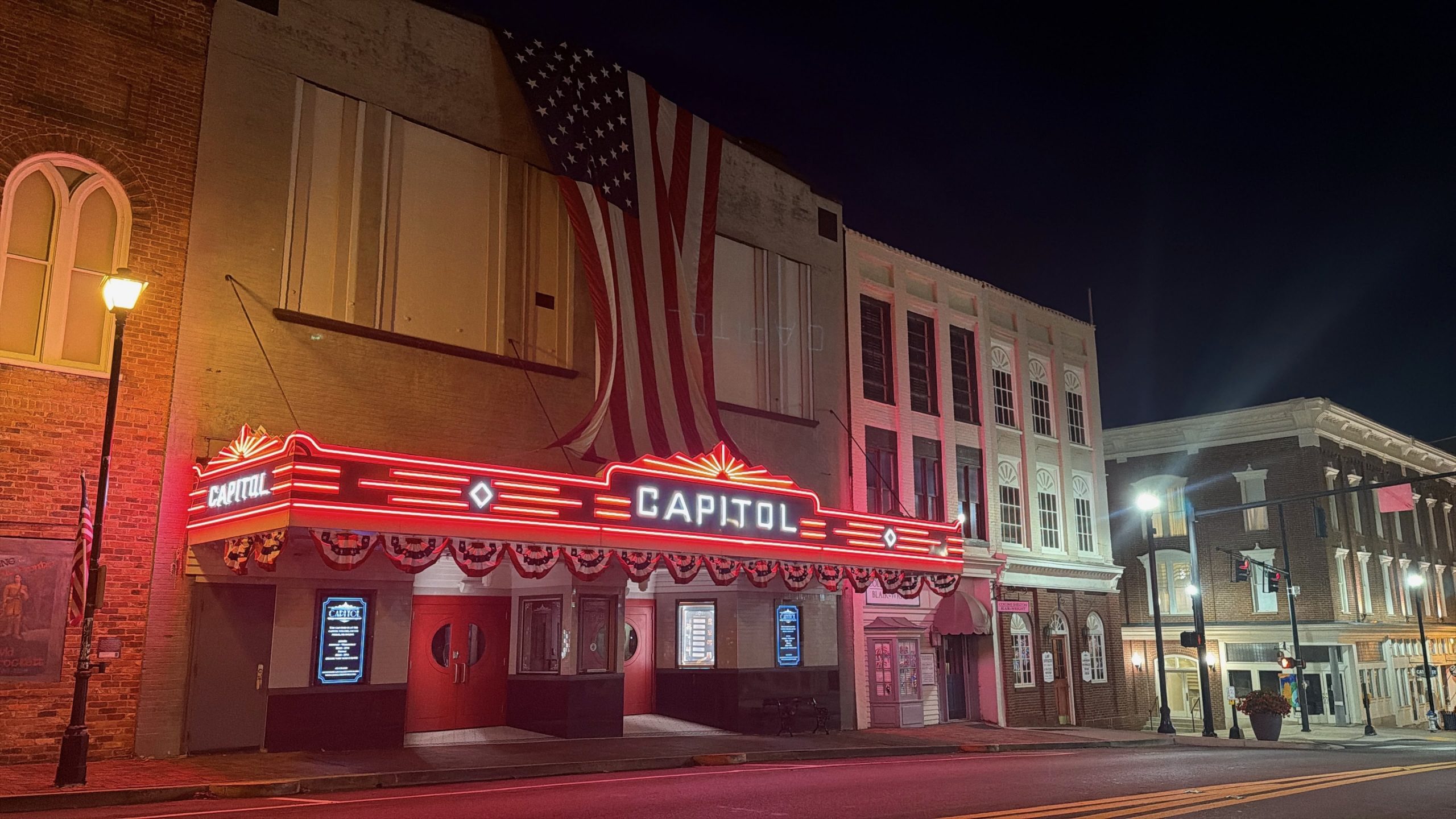 The Capitol Theatre in downtown Greeneville, Tennessee shown at night with fully restored RGB LED marquee and side blade signage by YESCO.