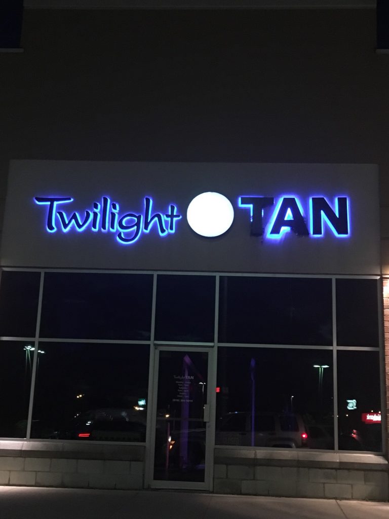 photo of Twilight Tan sign lit up at night