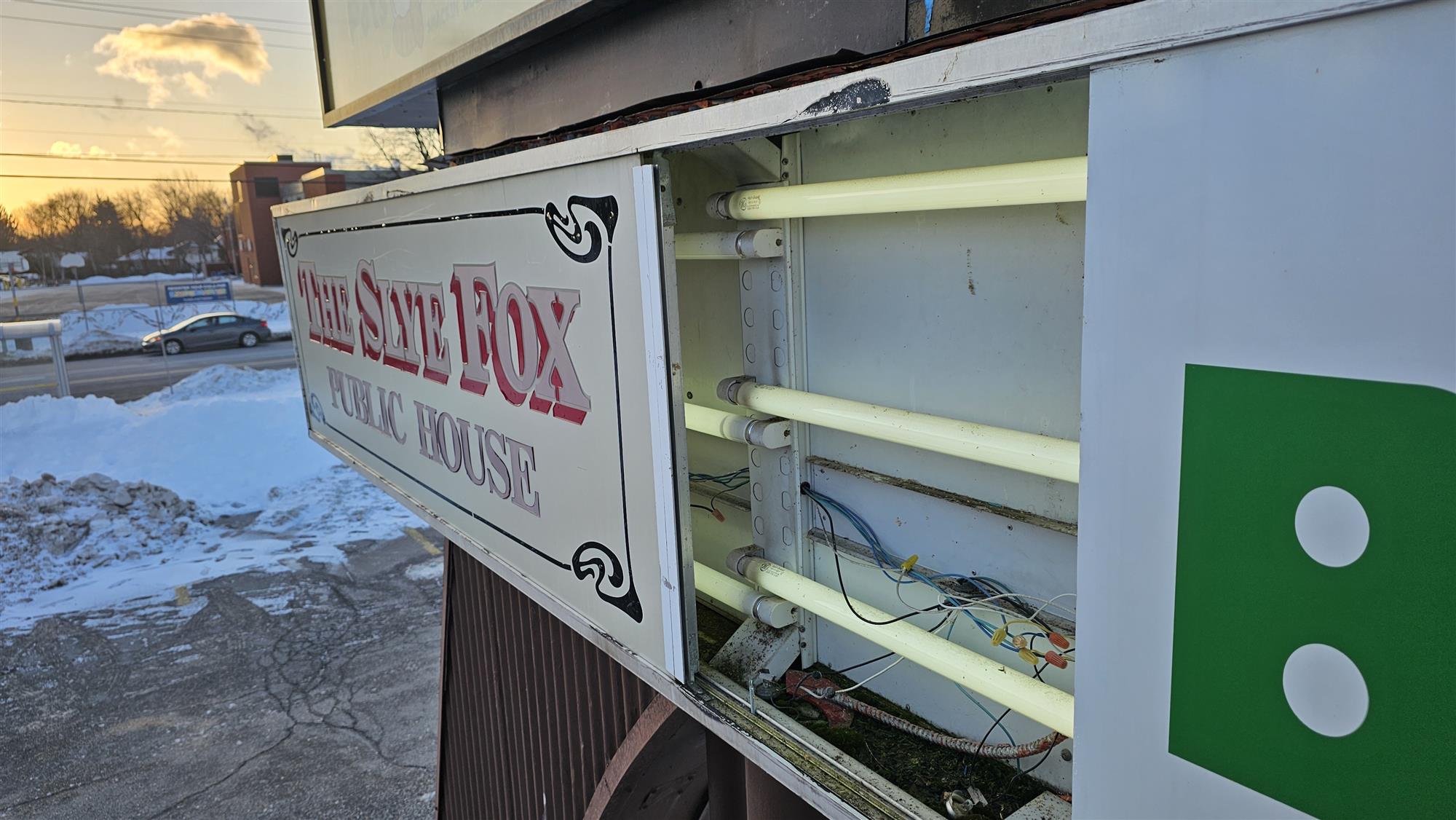 The inside of a pylon sign for the slye fox restaurant in Burlington