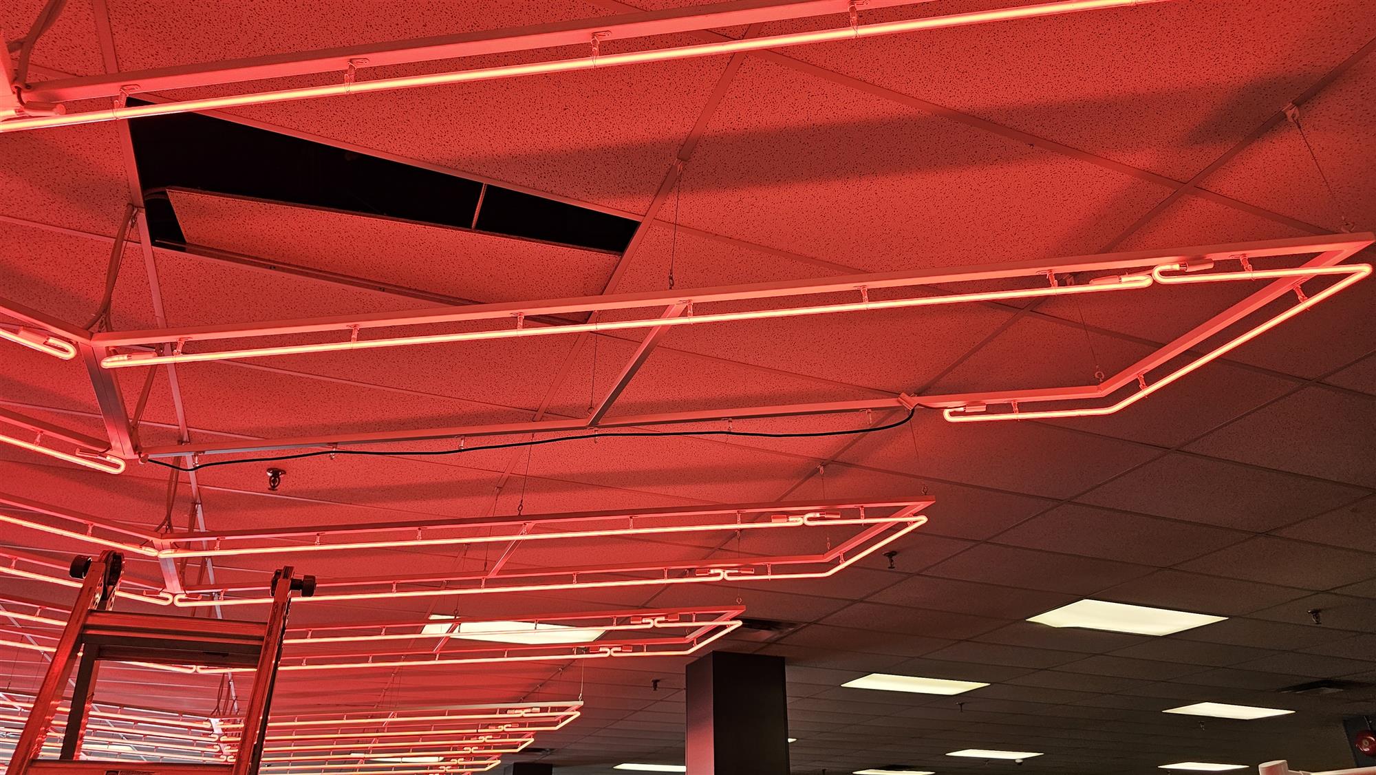 red neon lights on ceiling of Good Life Fitness
