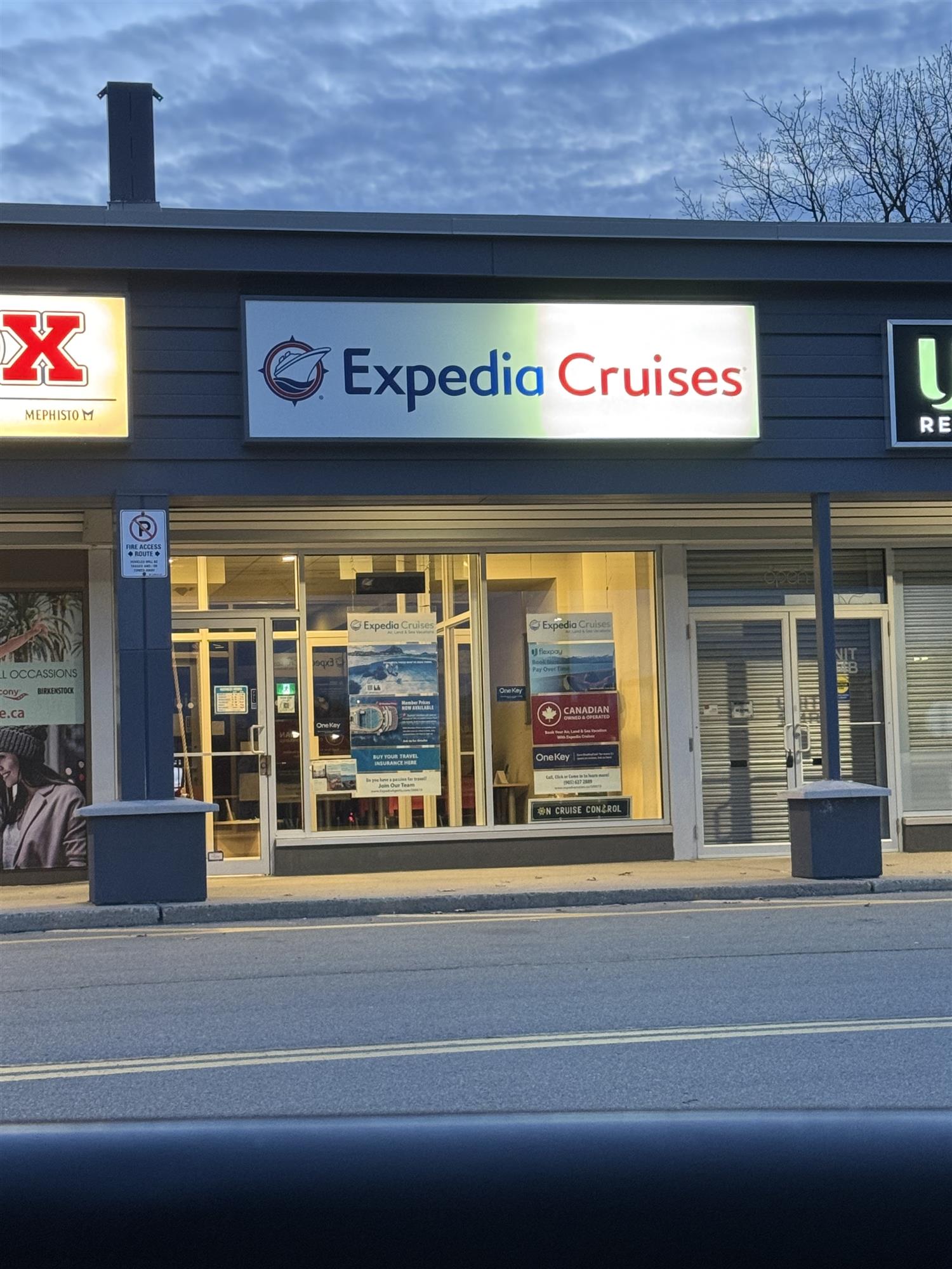 Expedia Cruises sign illuminated on front of building