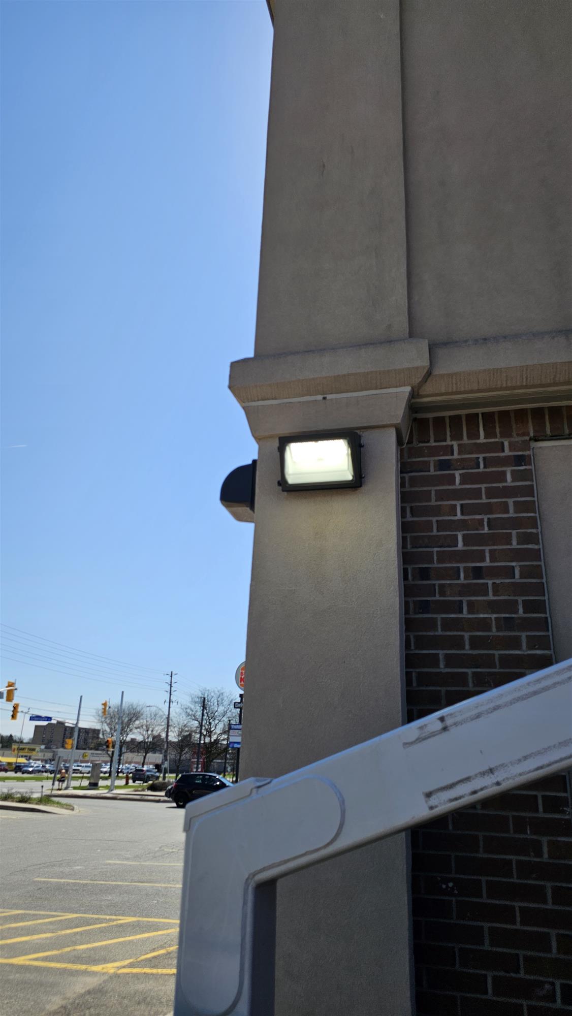 side of a building with an illuminated wall pack light