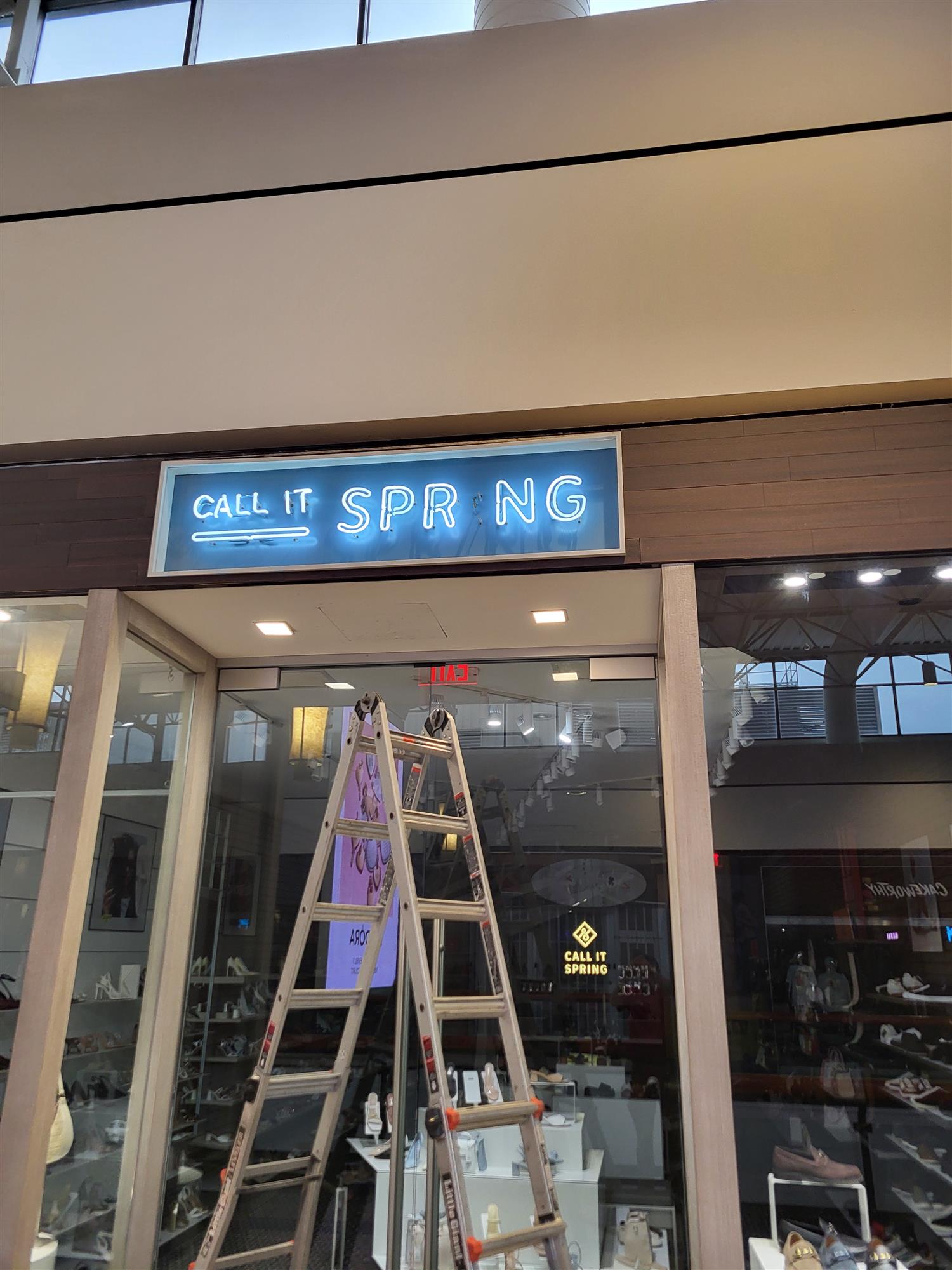 a neon sign with the letter i burnt out in the word Spring