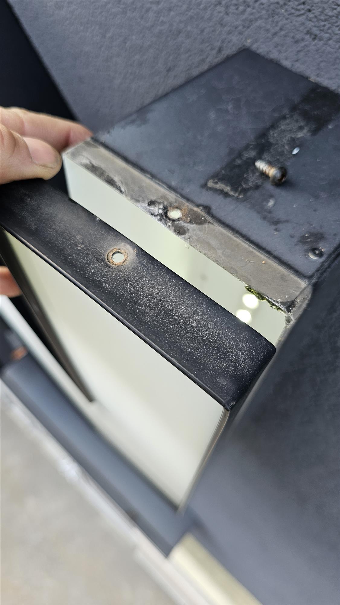 a metal timer box with screws removed