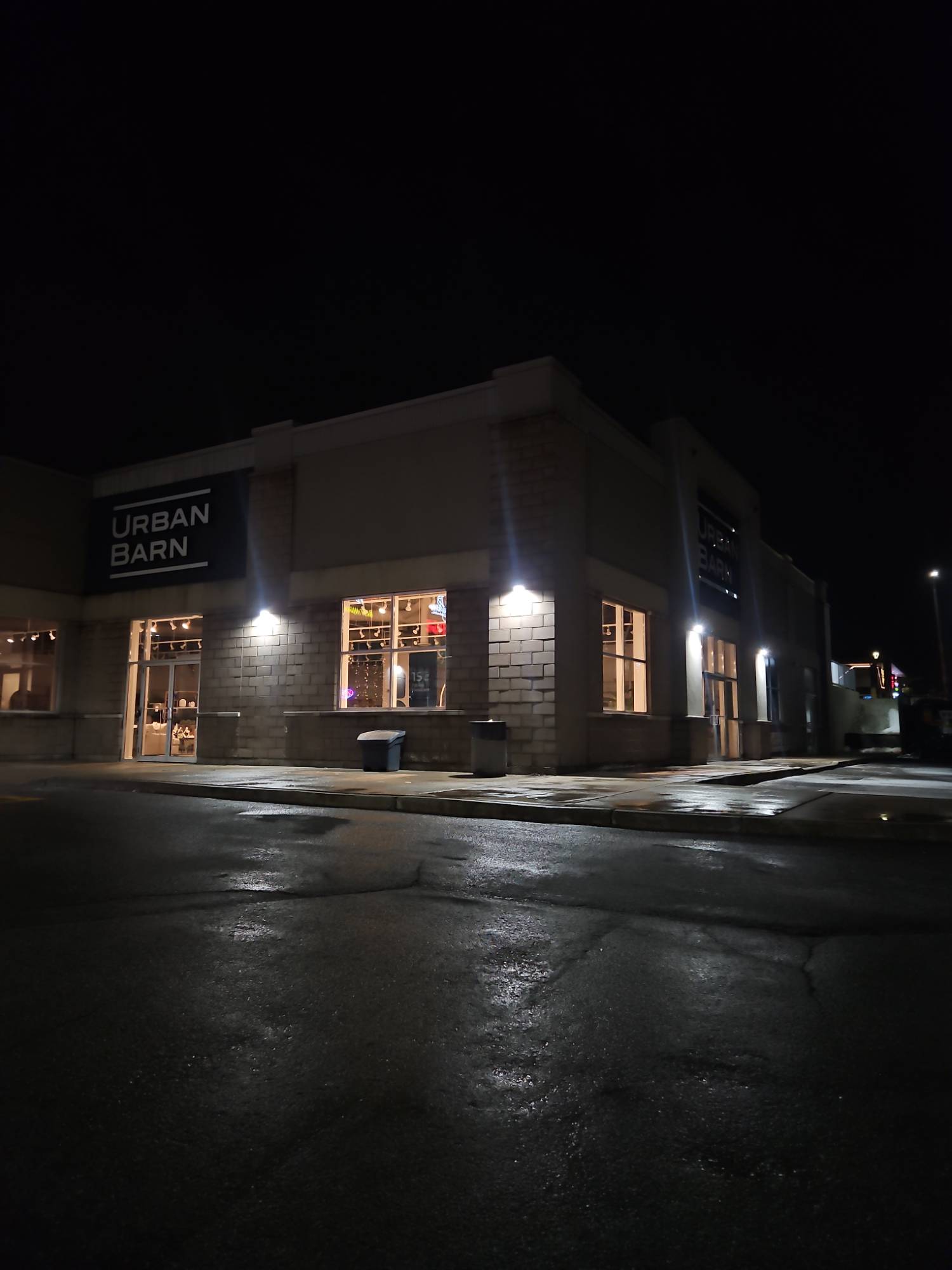 Urban Barn store at night with wall lights illuminated
