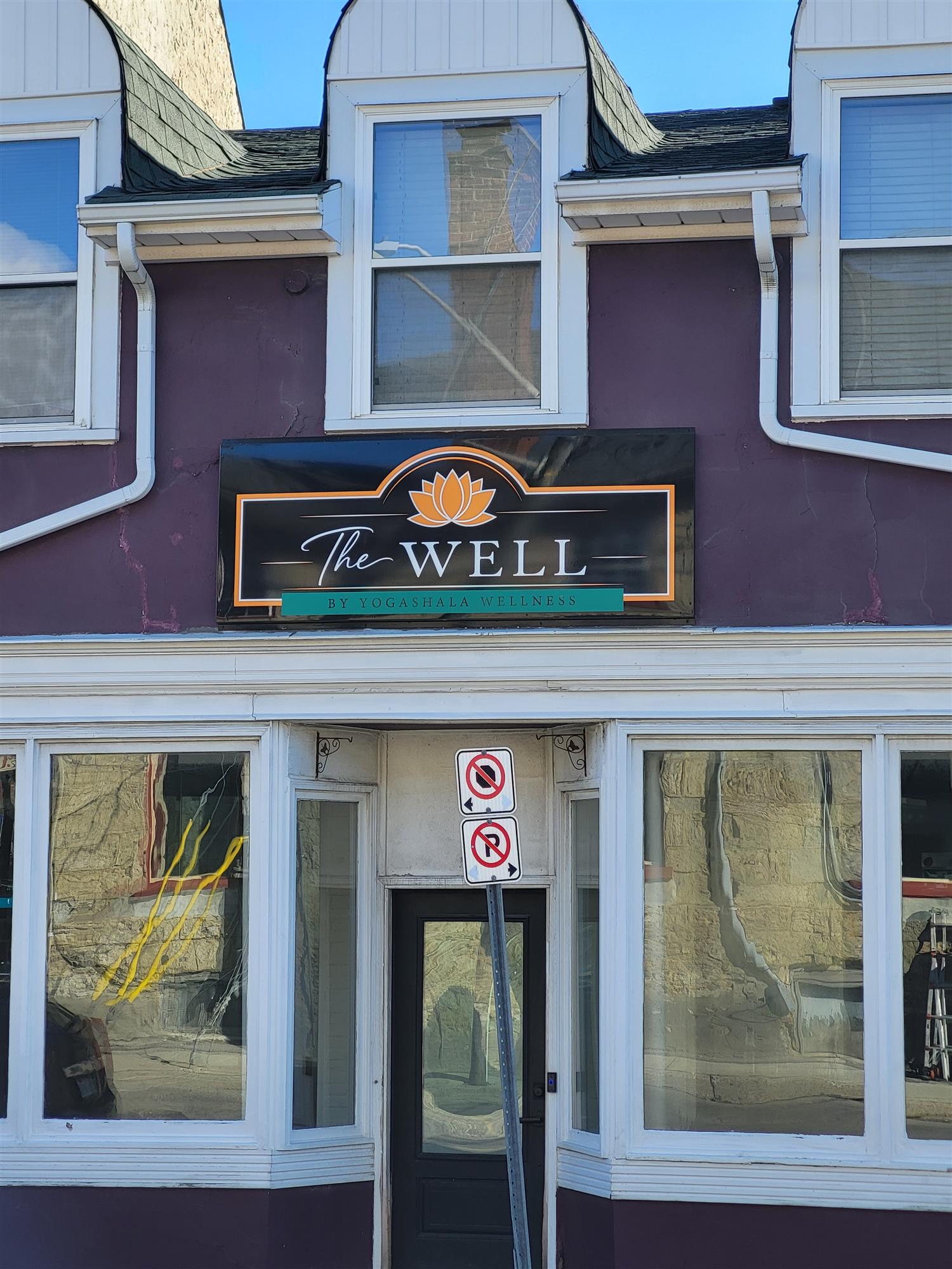 a purple building with The Well sign over the entrance