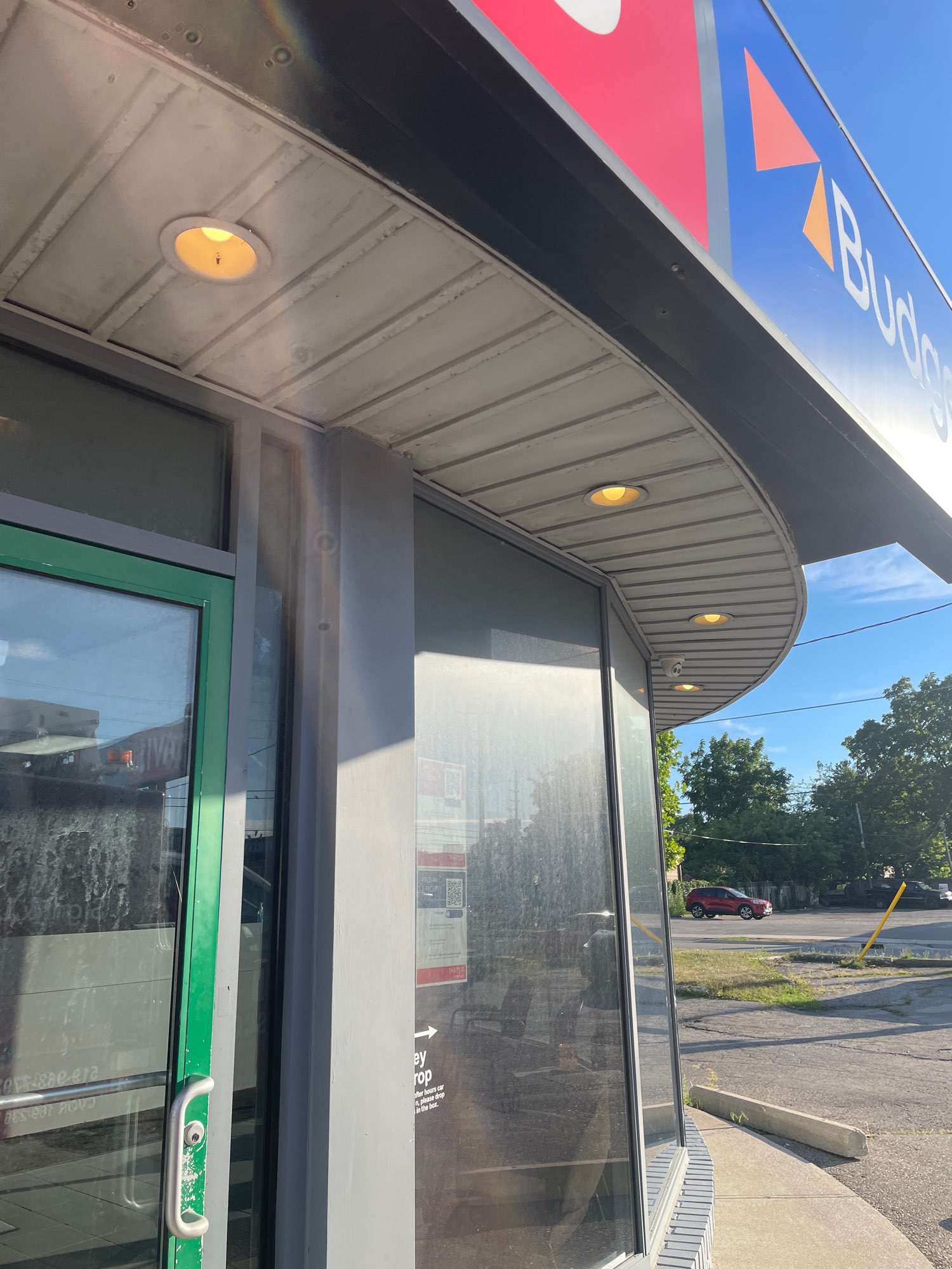 outdoor lighting under the Avis Car rental sign in London Ontario