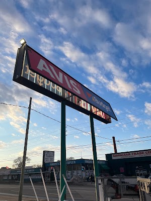 a red and white Avis car rental sign being repaired