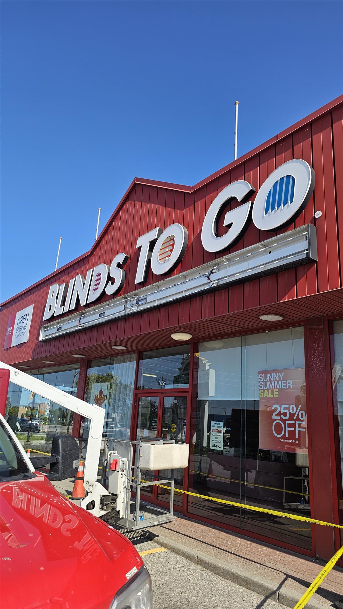 white Blinds to Go sign with open section underneath letters showing bulbs