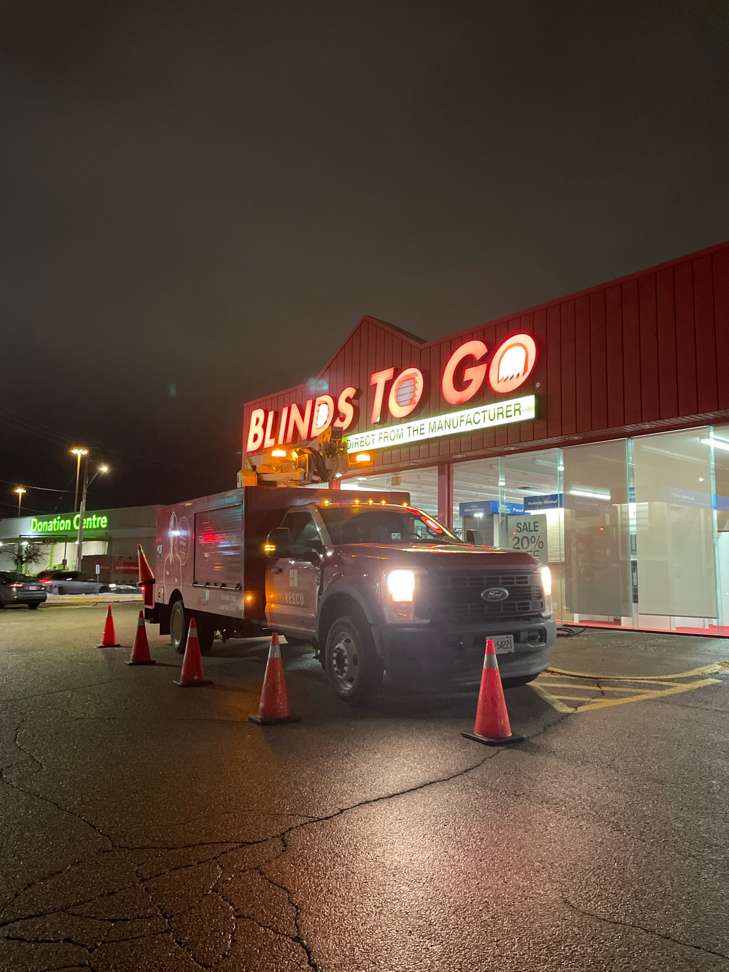 a night view of Blinds to Go sign undergoing a channel letter repair to LED neon