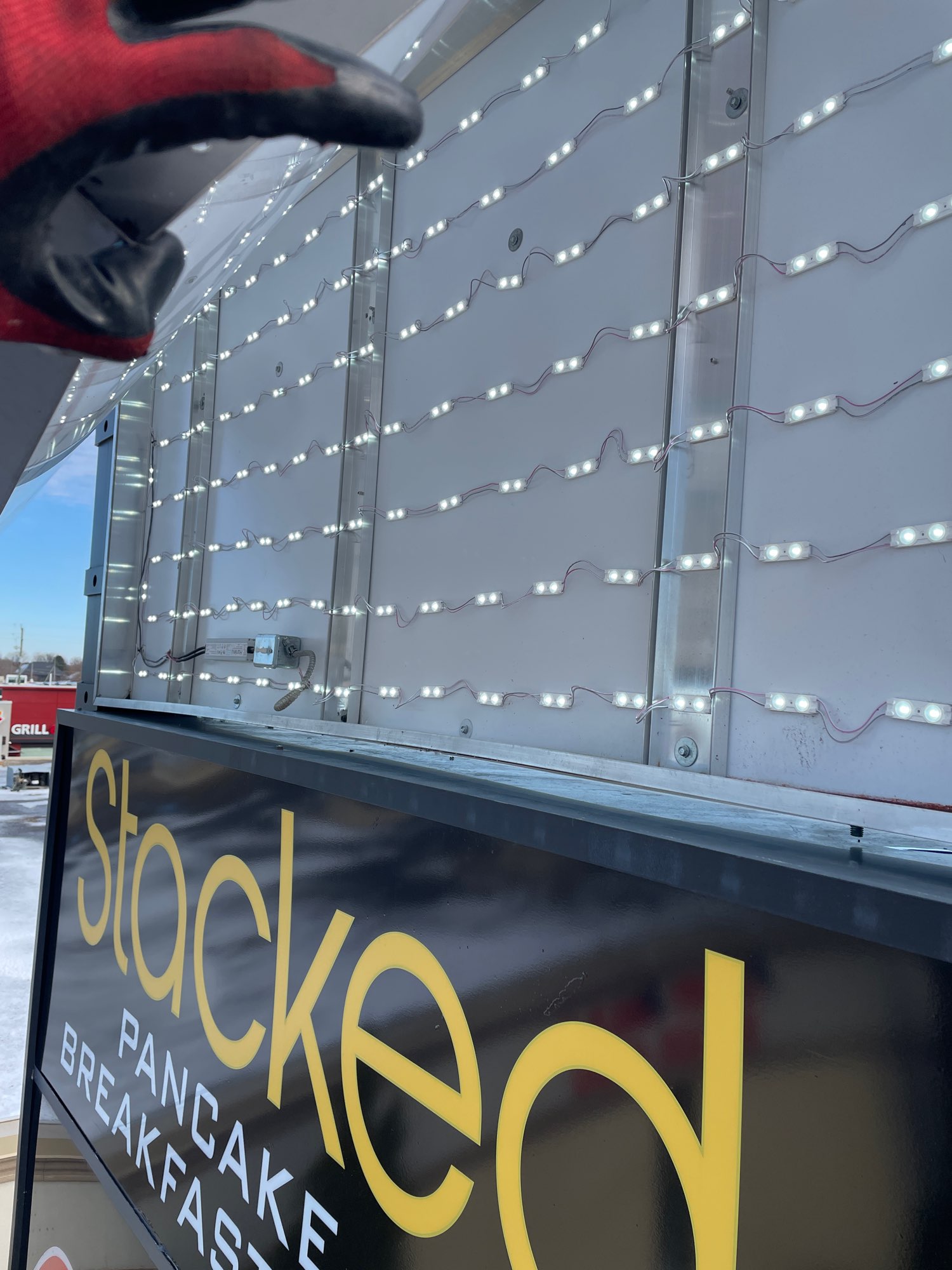 inside of pylon sign showing strands of illuminated LED lights