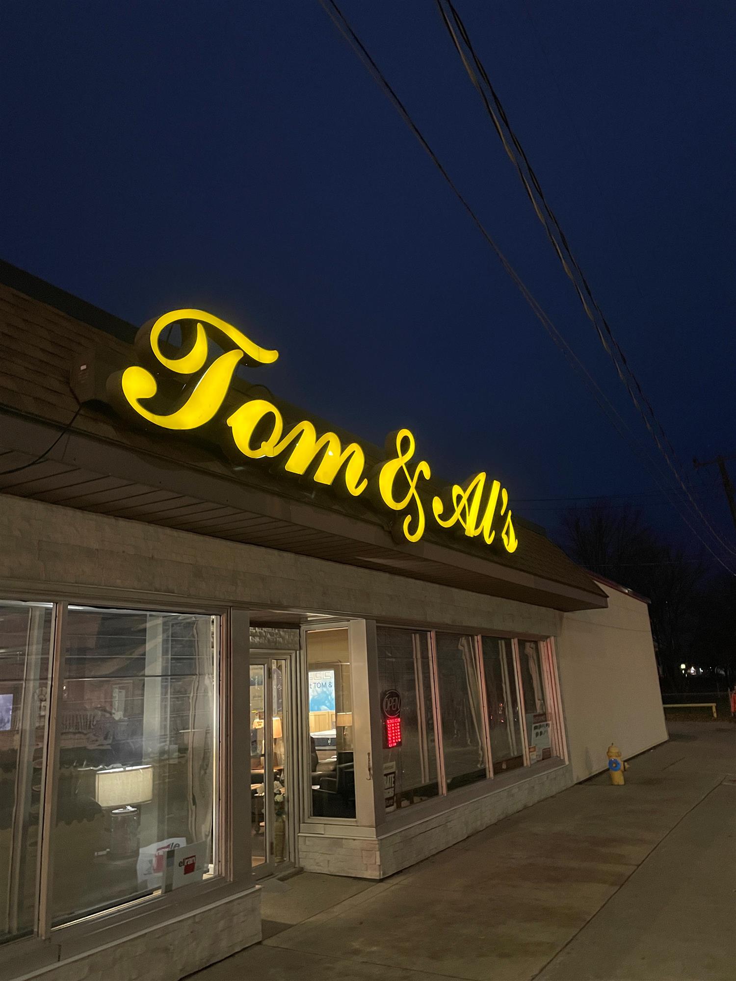 nighttime view of Tom and Al's sign