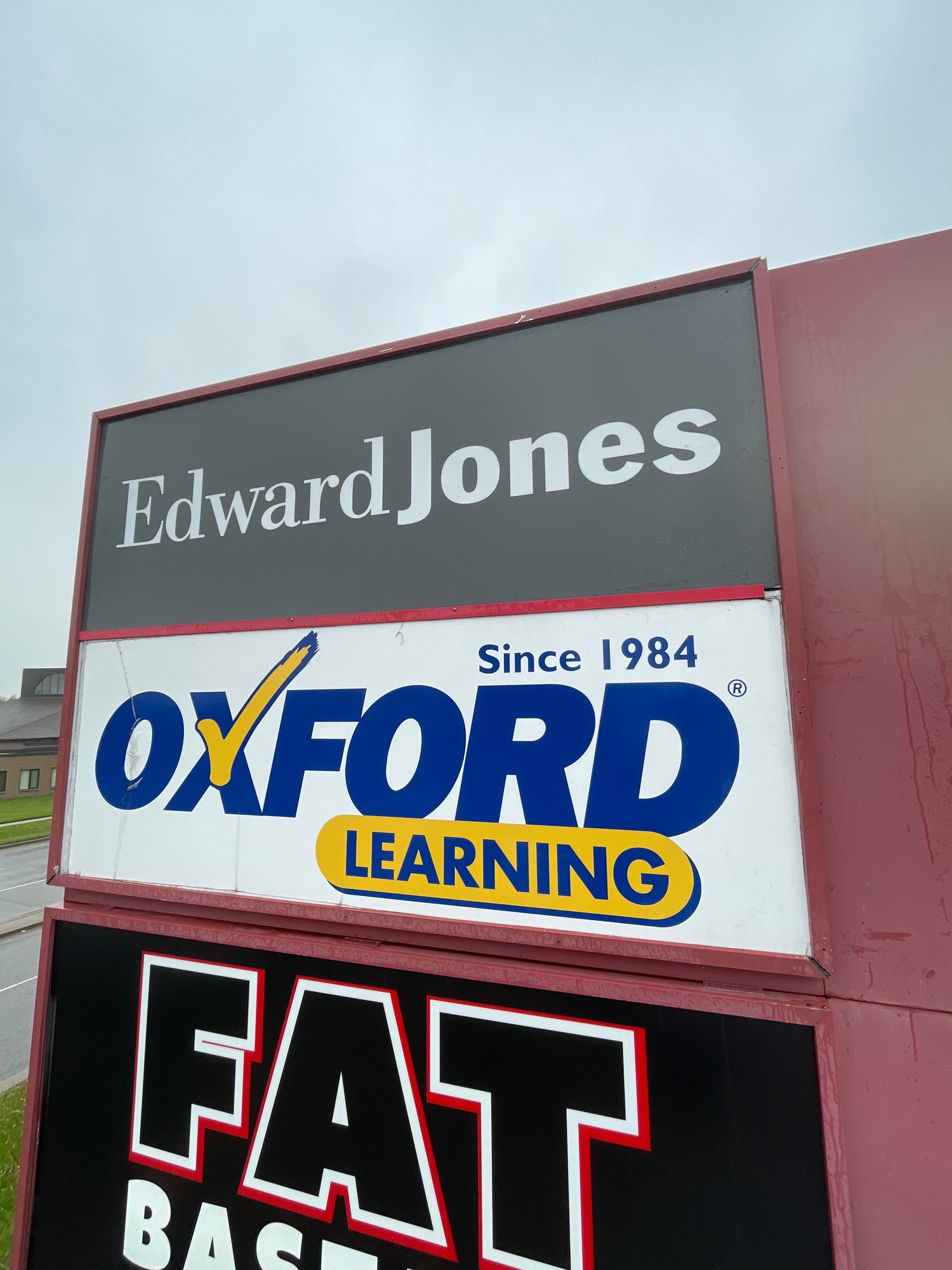 a pylon sign of Edward Jones and Oxford Learning on Wonderland road in London Ontario