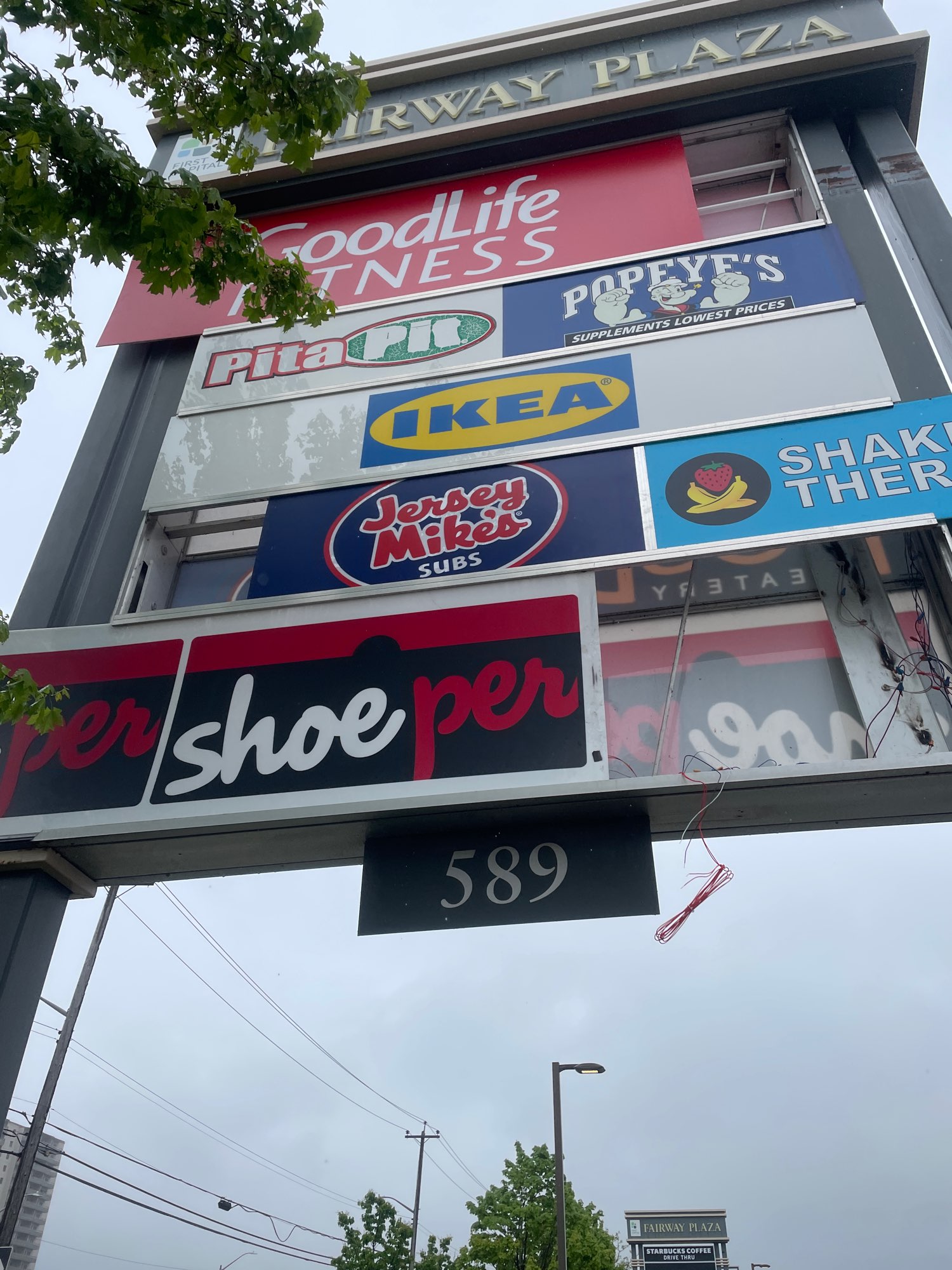 multi coloured Fairway plaza pylon sign with 8 businesses listed in Kitchener Ontario