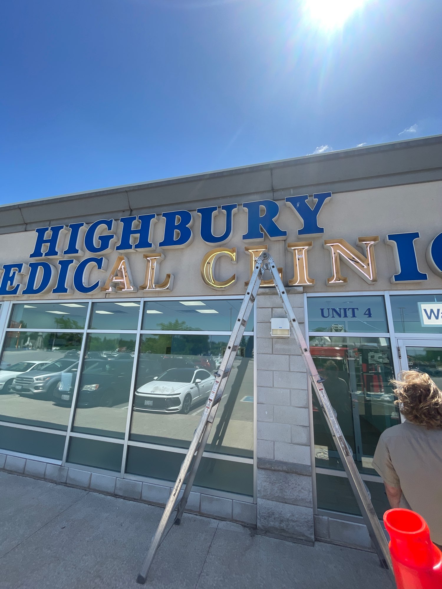 an outdoor building sign with large blue letters for Highbury Medical Clinic in London Ontario