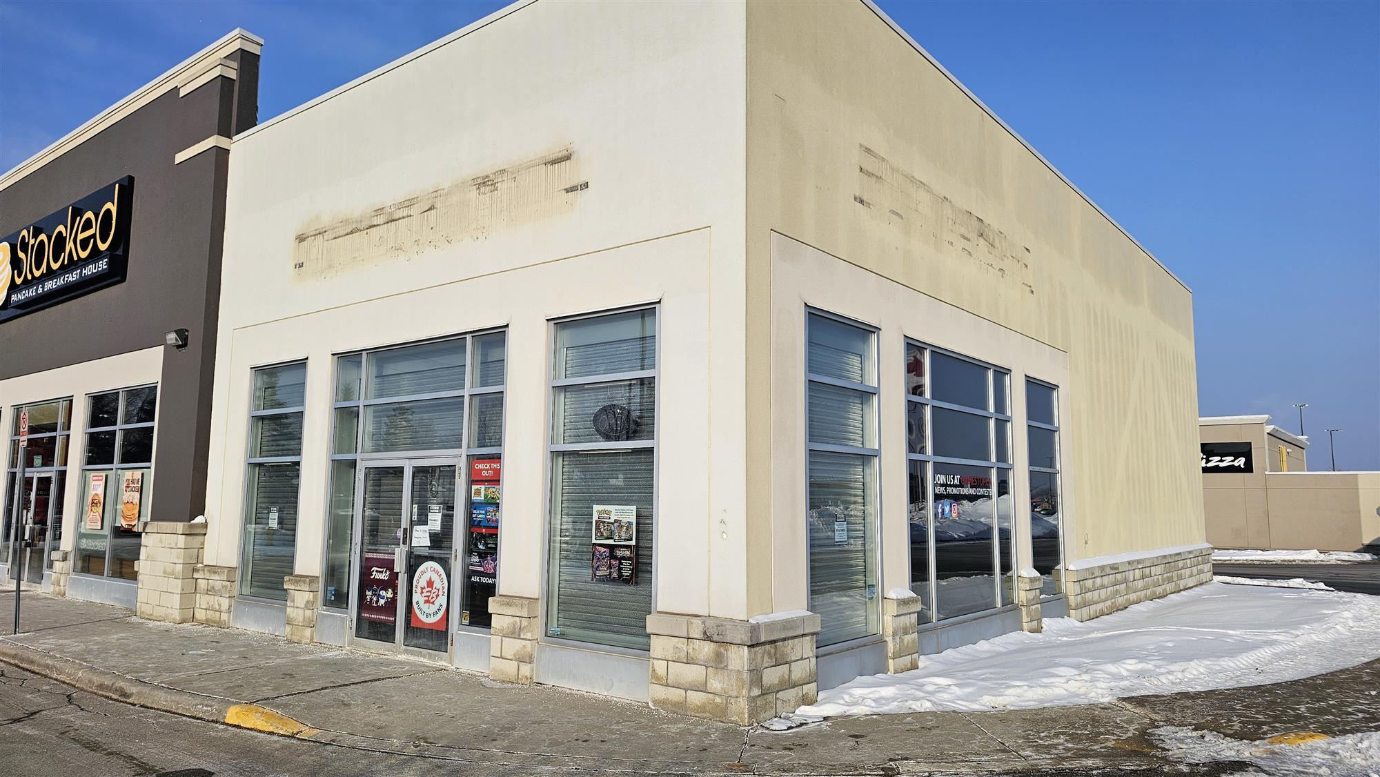 a store showing the sign had just been removed from the front and side of the building