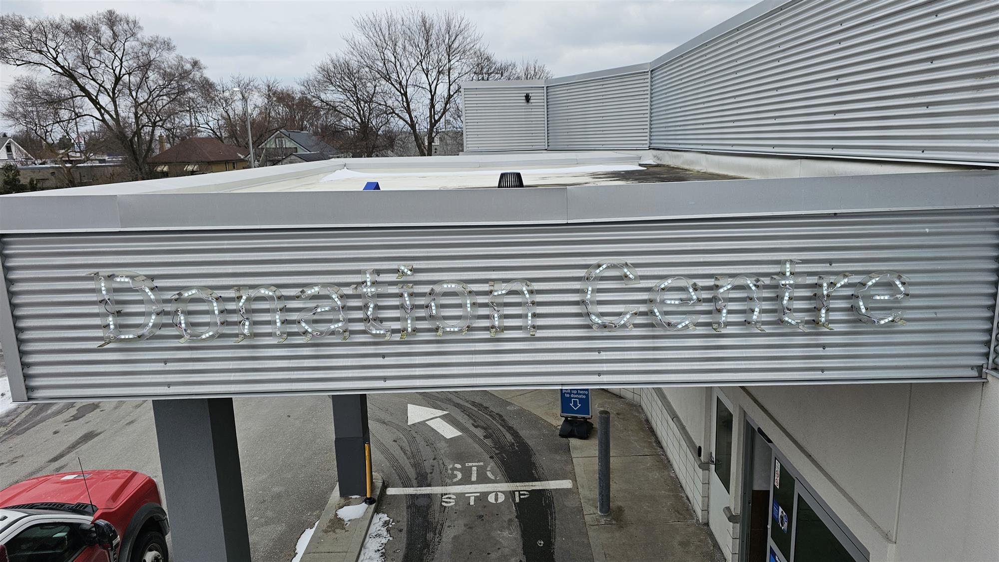 large Donation Centre sign with face removed showing the LED lights