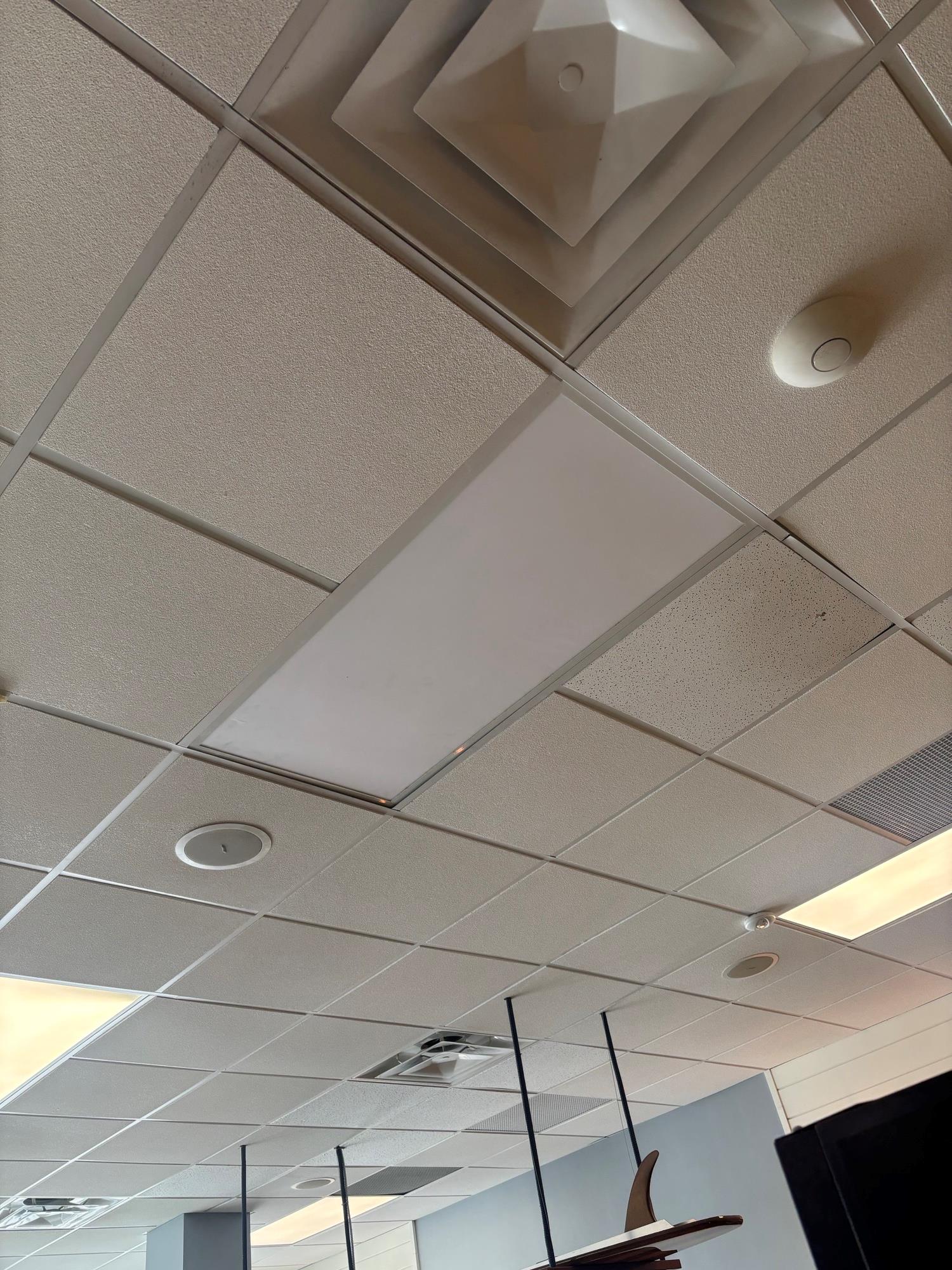 white ceiling tiles at Jersey Mike's restaurant showing the LED panel