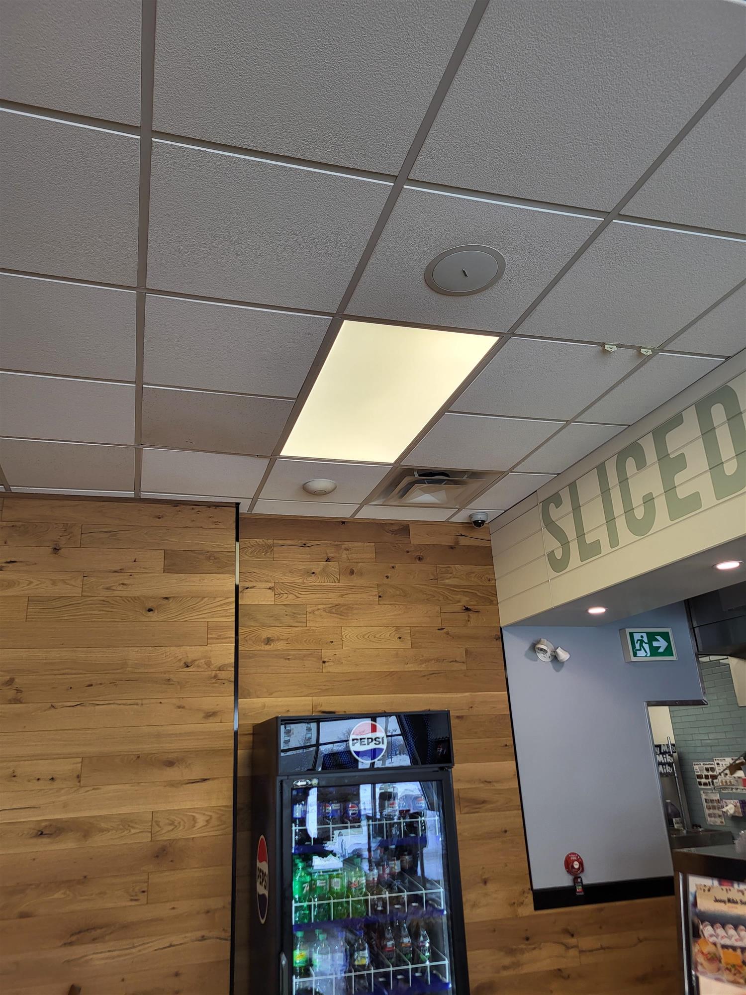 inside Jersey Mike's restaurant showing the new LED ceiling panel and a Pepsi machine full of pop