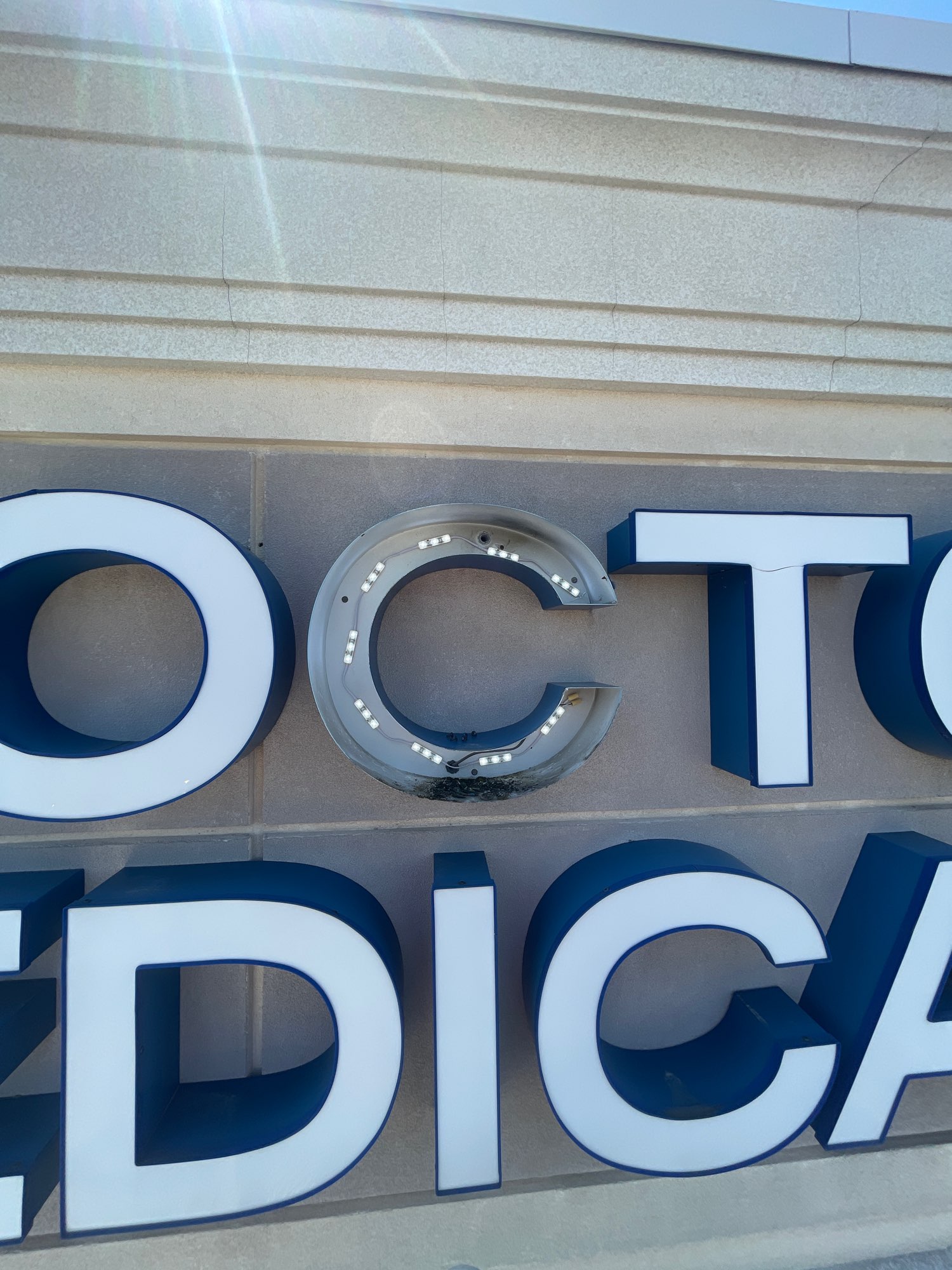 a sign with letters showing the inside LED lights of the letter C