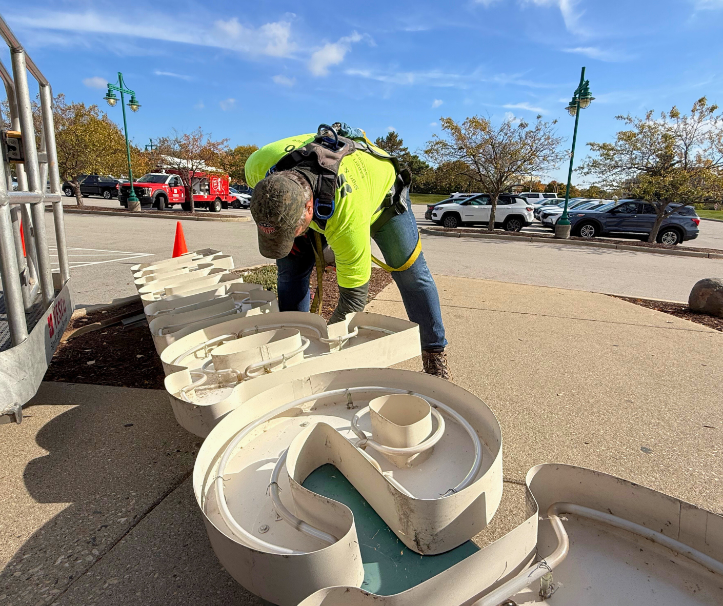 YESCO employee repairing channel letters