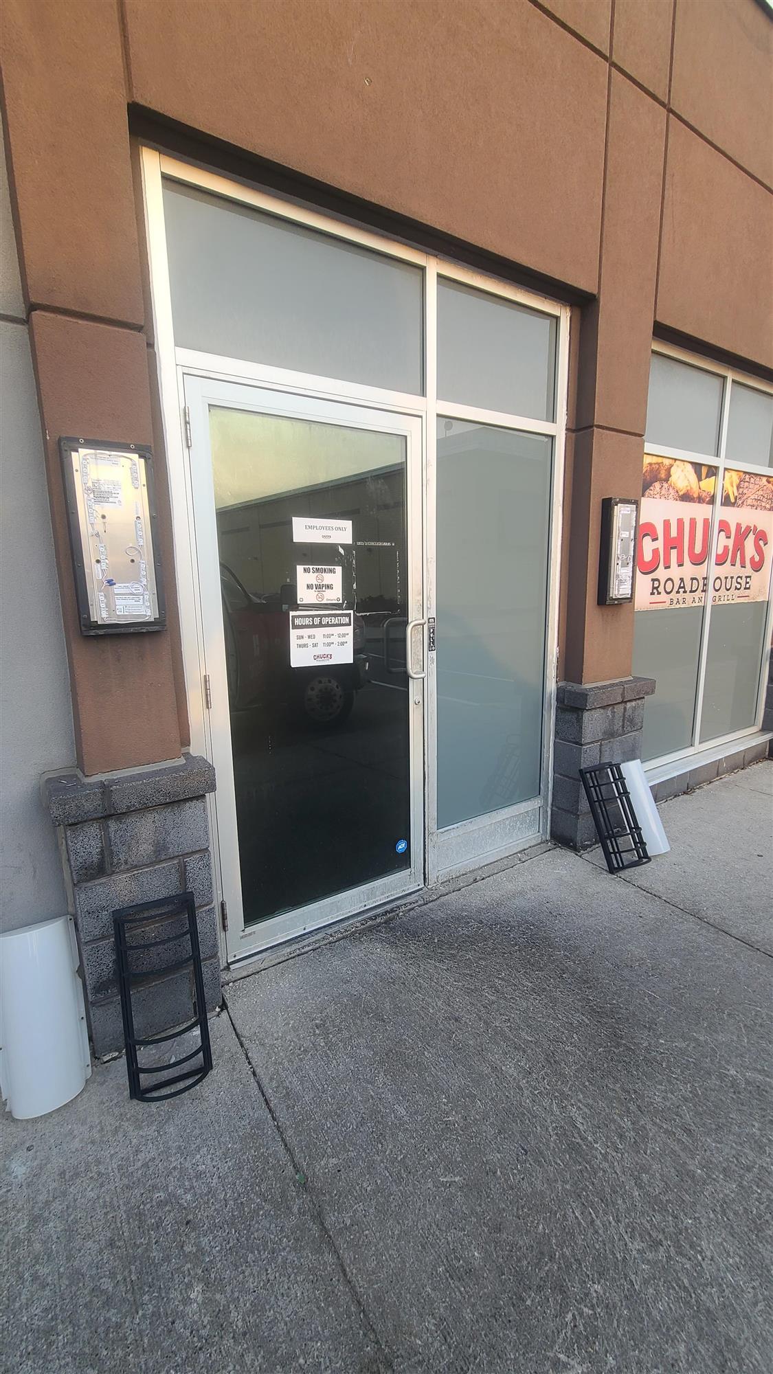 wall sconces on the side of Chucks roadhouse restaurant opened up for repair