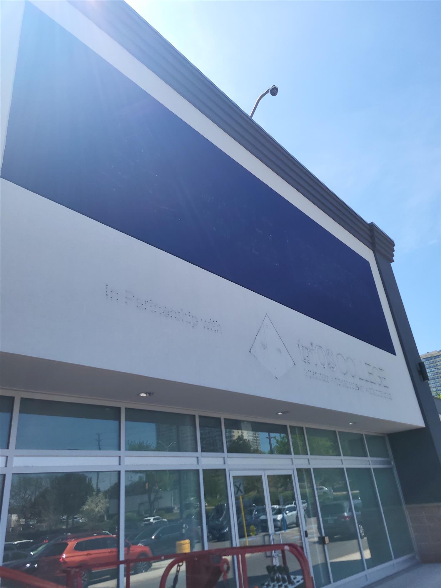 A blue and white store front on a building with the sign removed