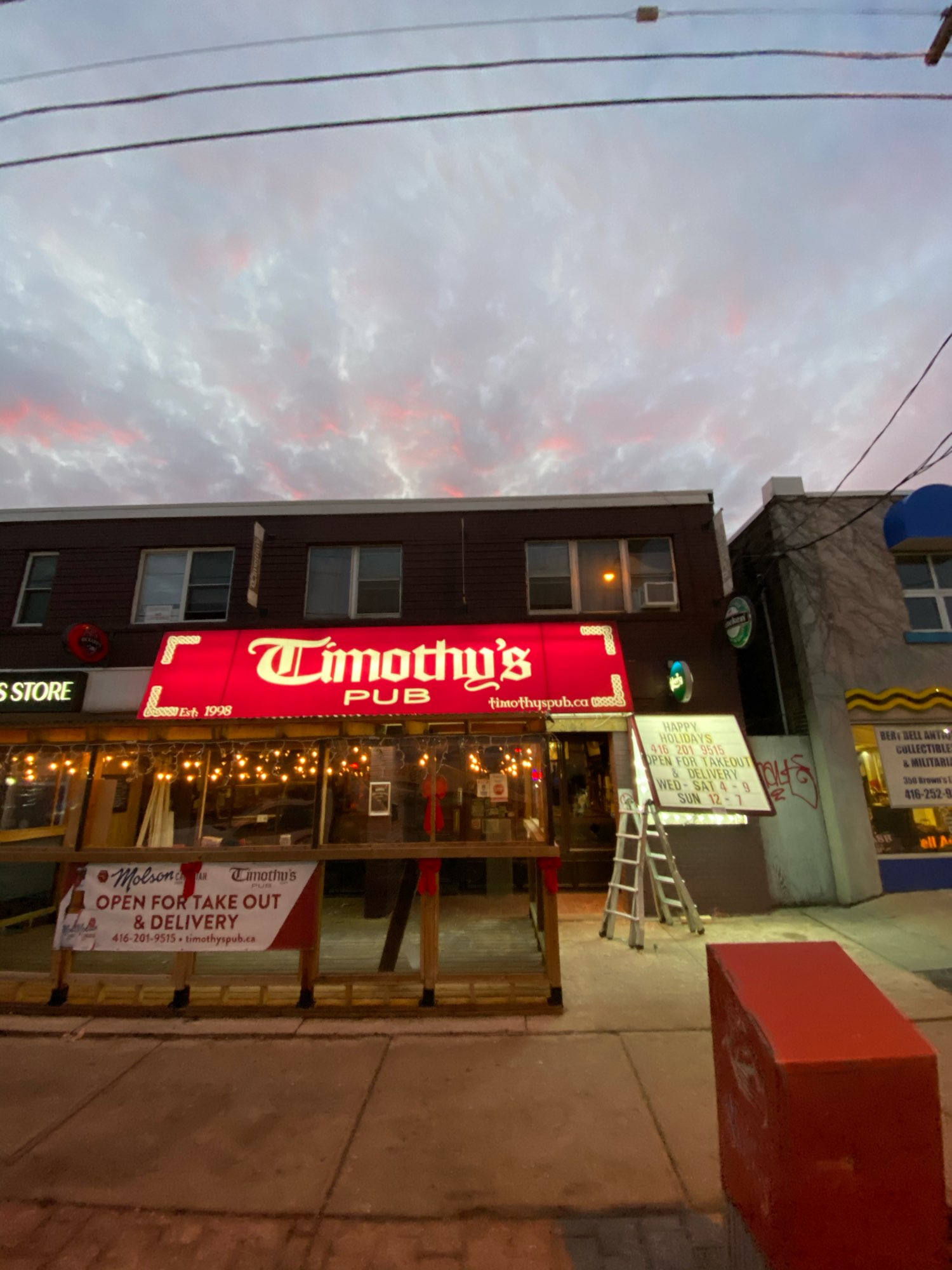 red and White Timothy's Pub sign over restaurant entrance