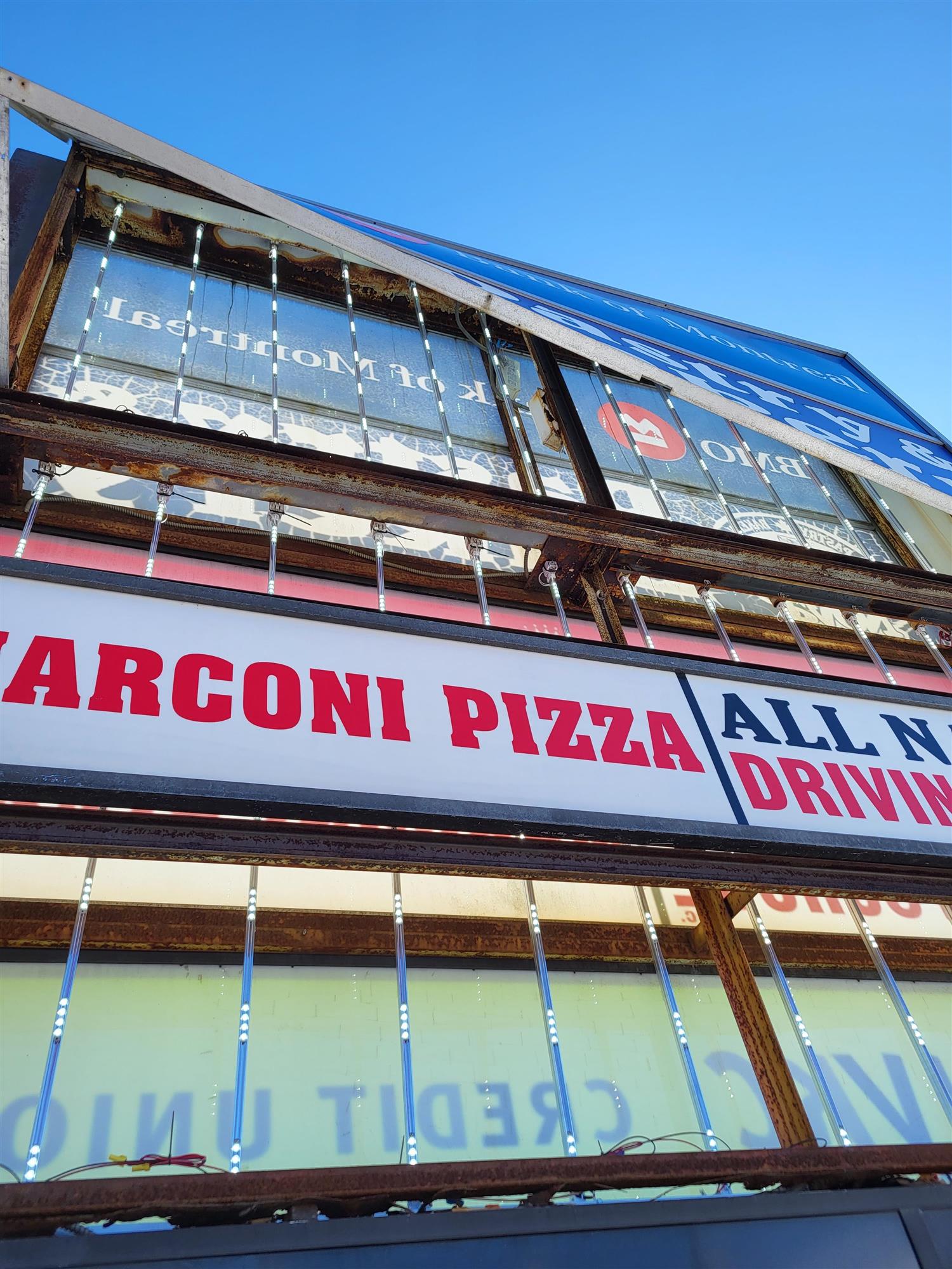 a large pylon sign with several business signs