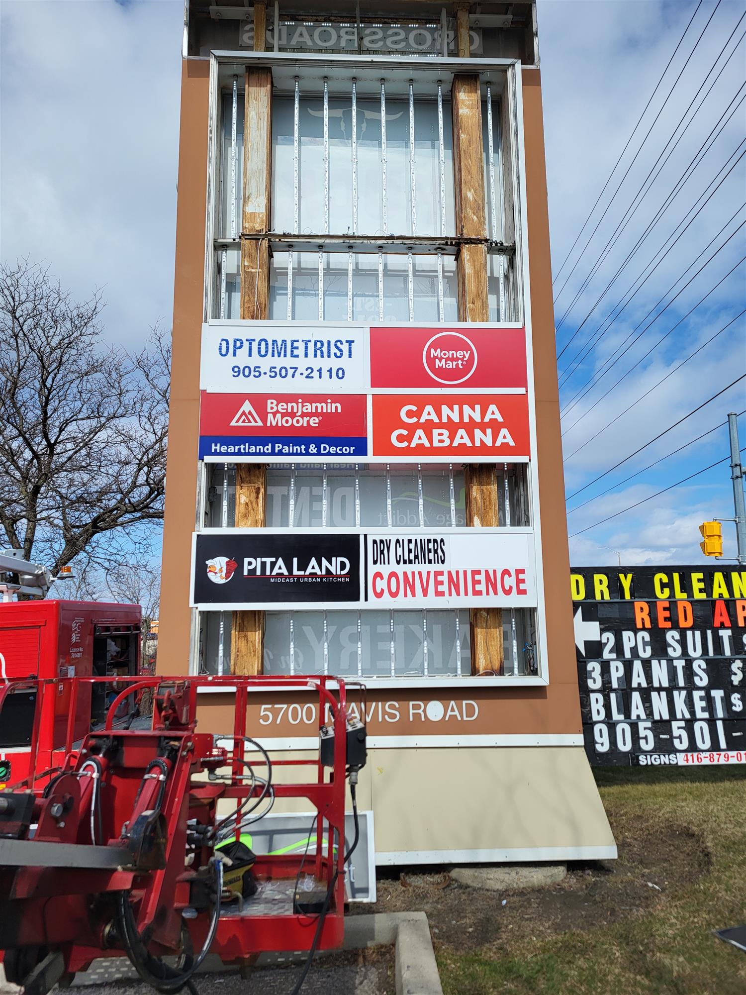 a large pylon sign with the inside exposed for repair work