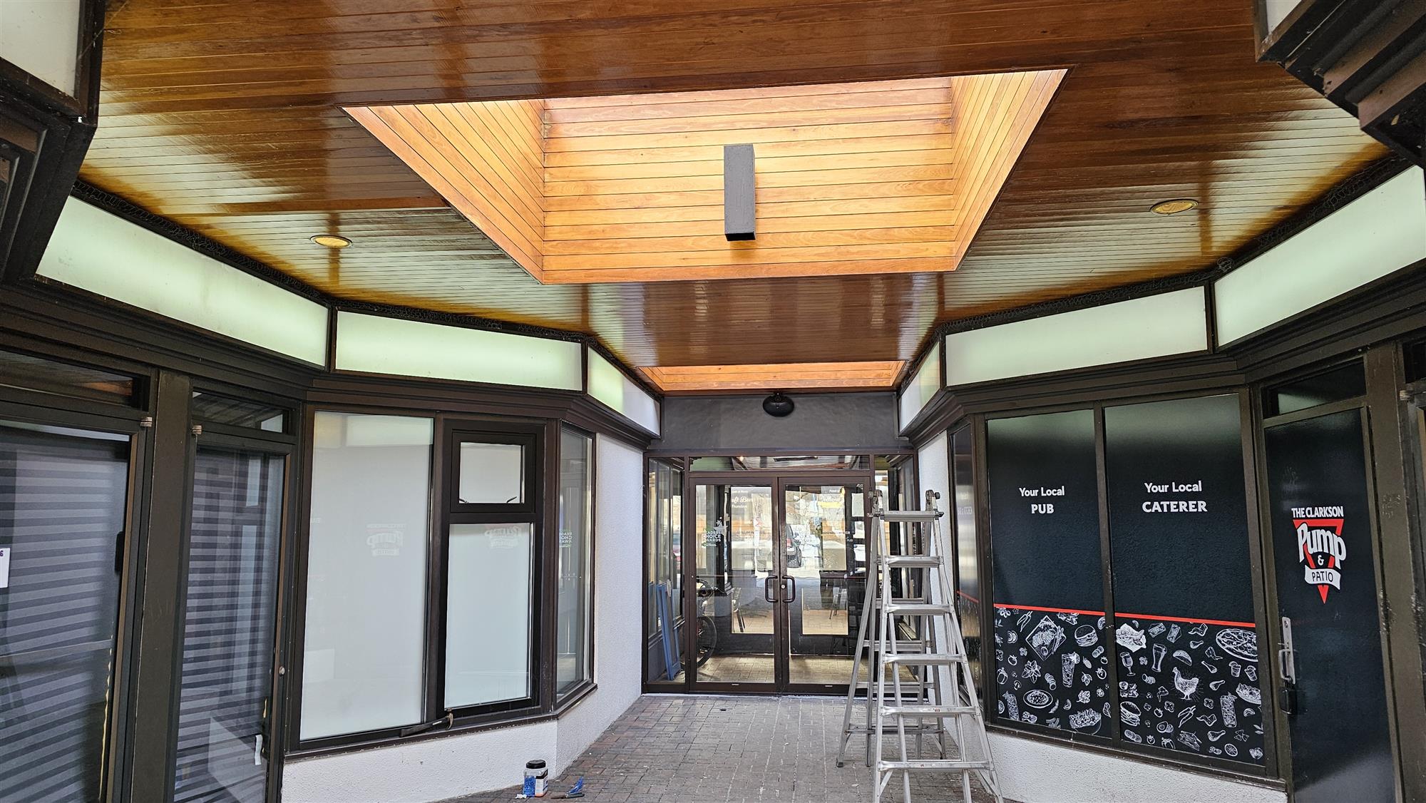 the foyer of a small mall of stores with lights replacements