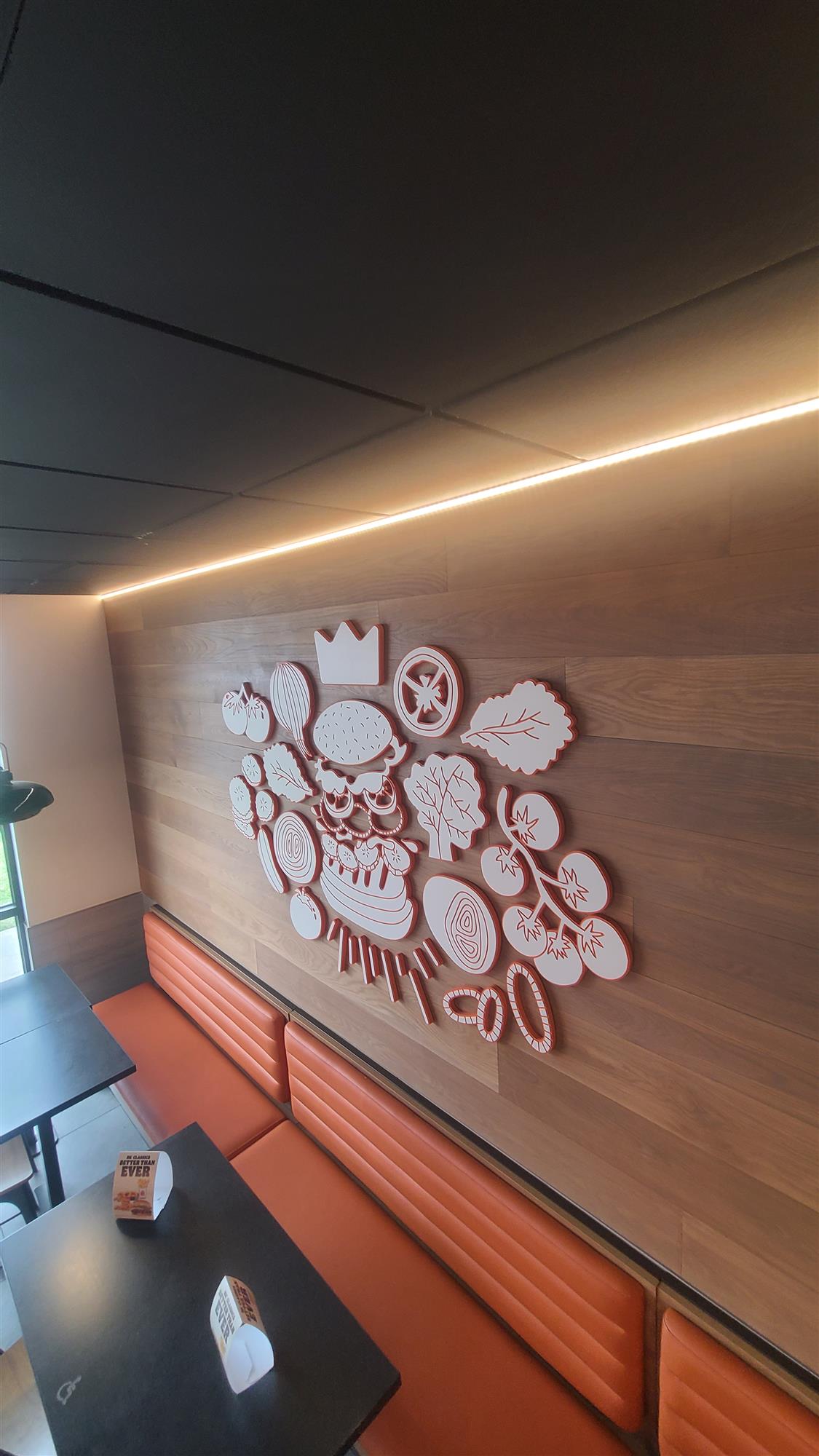 LED light strip above seating inside Burger King