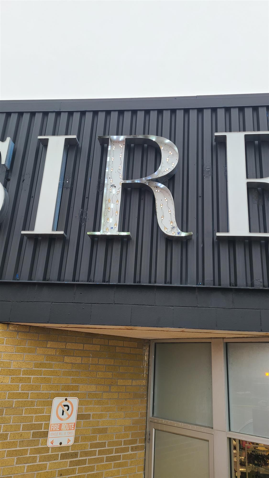 an open Sirens sign exposing the led bulbs of the letter R