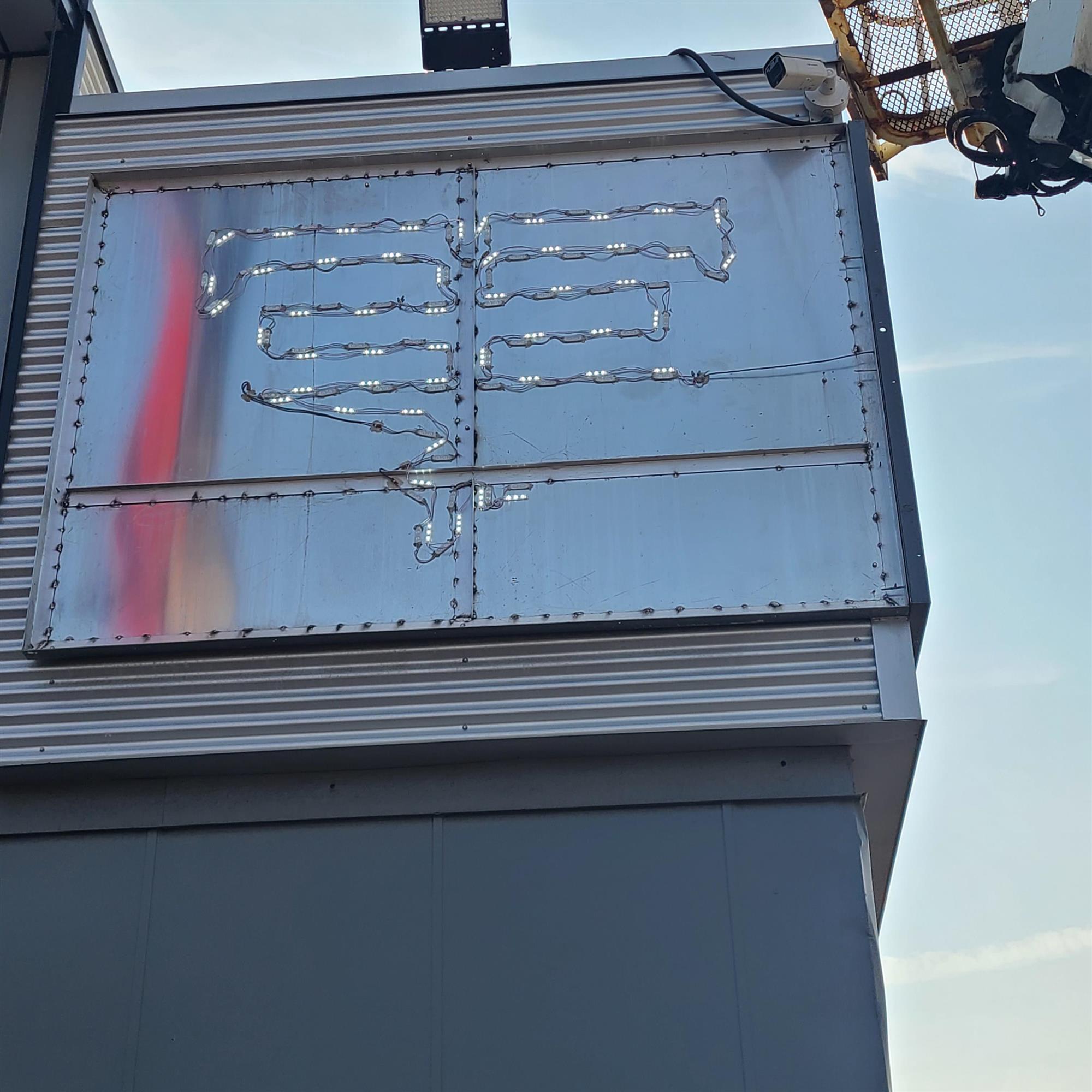 the inside of a large sign on the side of a building with LED lights