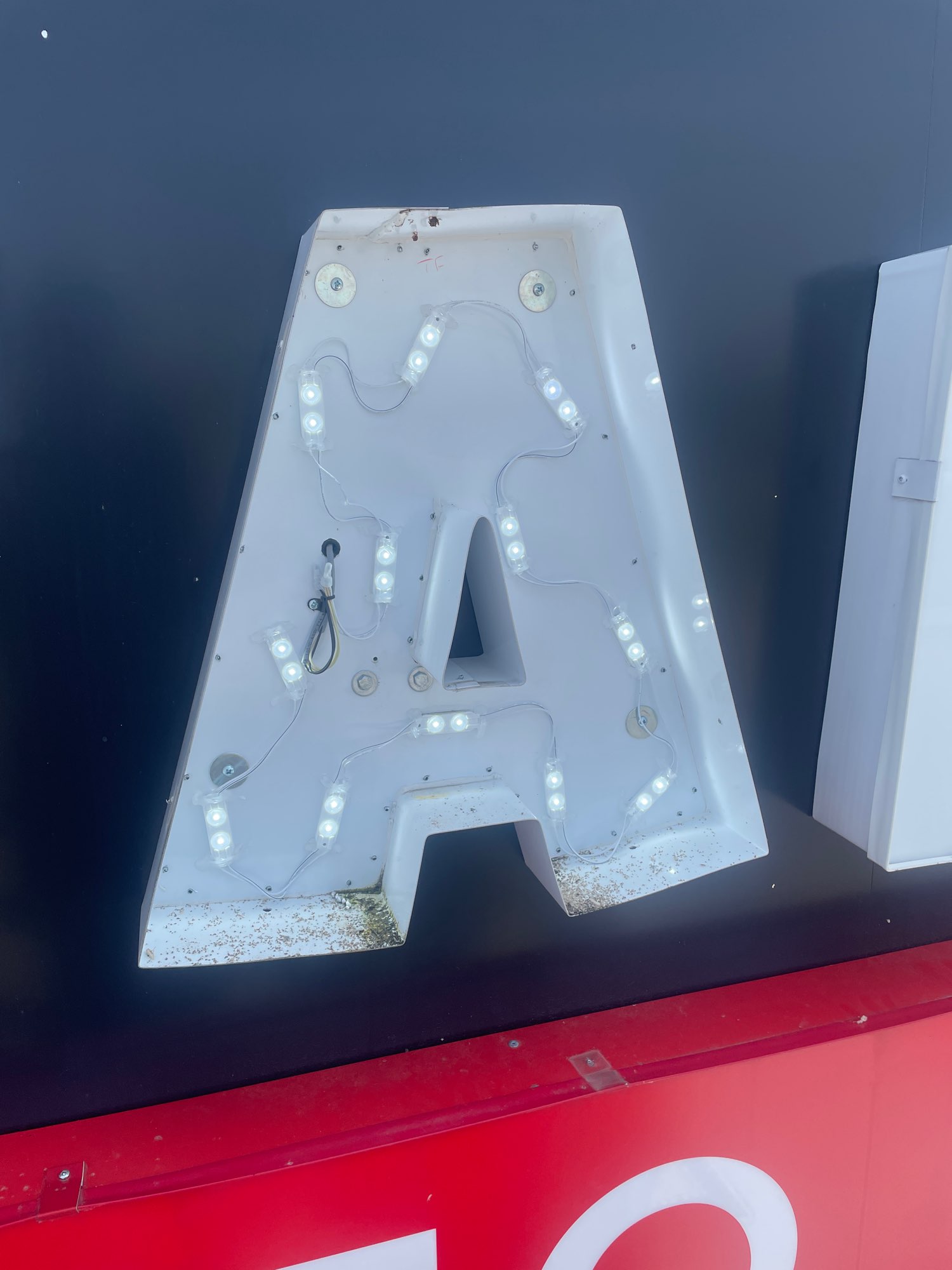 The inside of a letter A from a sign showing the internal lights