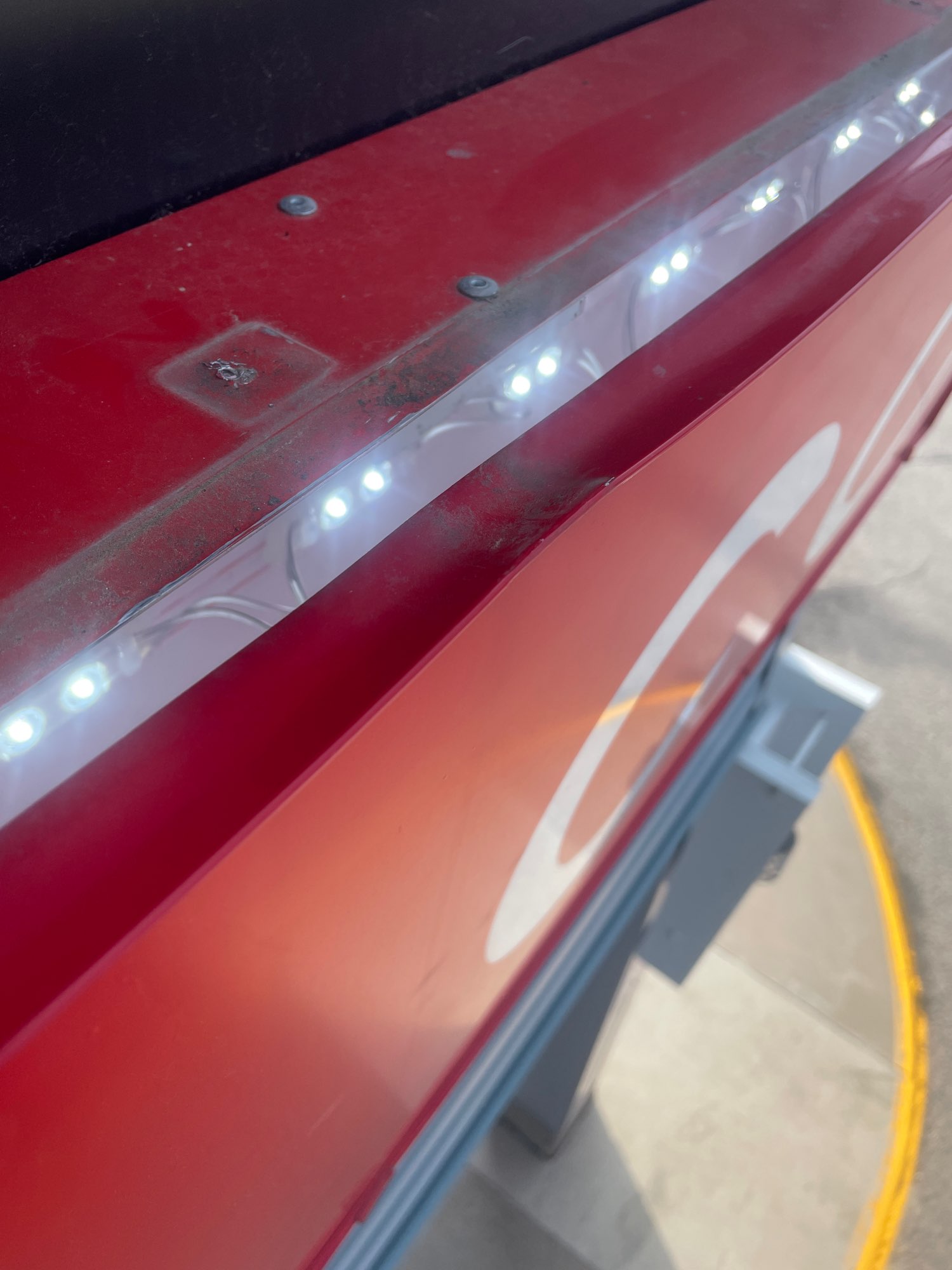 a large red sign with small white lights across the top of it