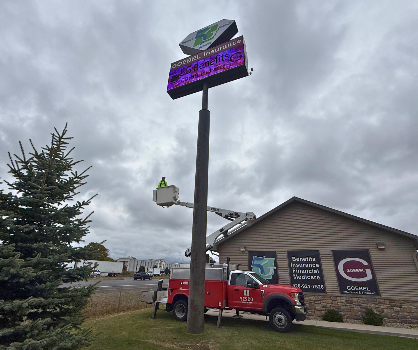 yesco employee servicing a digital sign