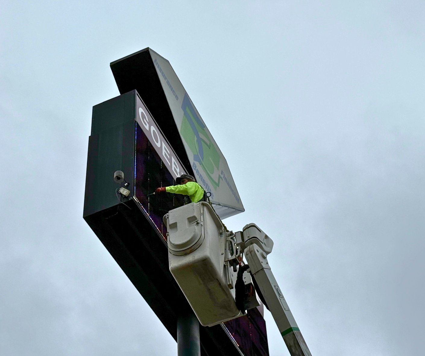 YESCO employee fixing exterior signage